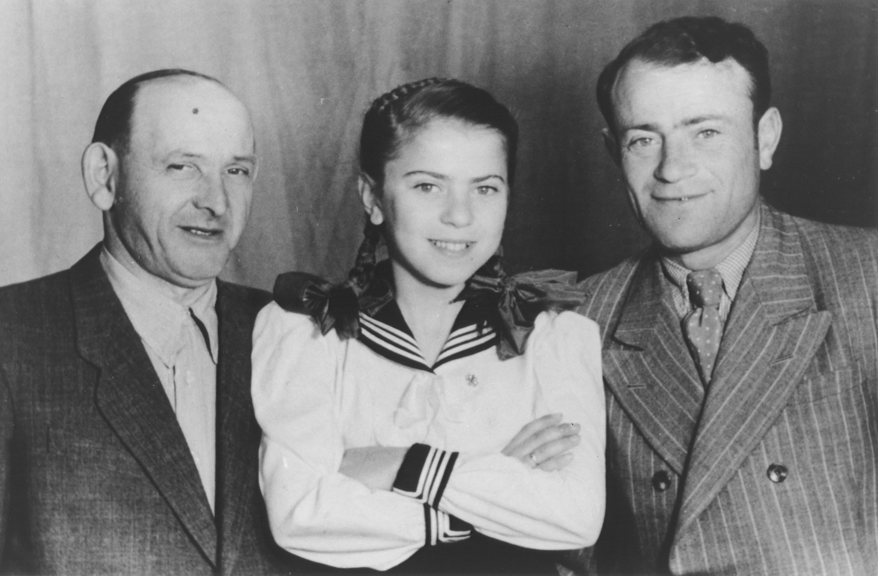 Chuma Rendler poses with her father Anchel and his cousin Israel Shusterkatz in a studio photo in the Tempelhof DP camp.