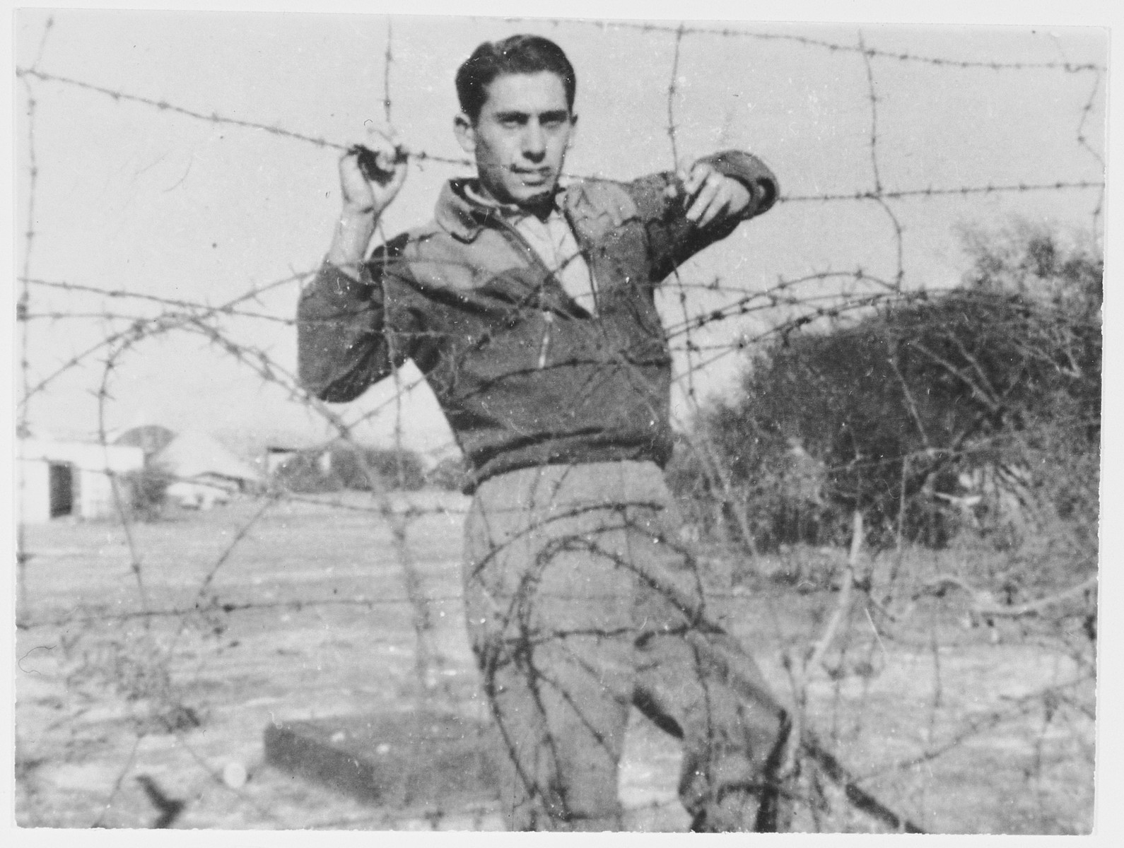 Haim Solomon poses next to the barbed wire fence surrounding the internment camp in Cyprus.