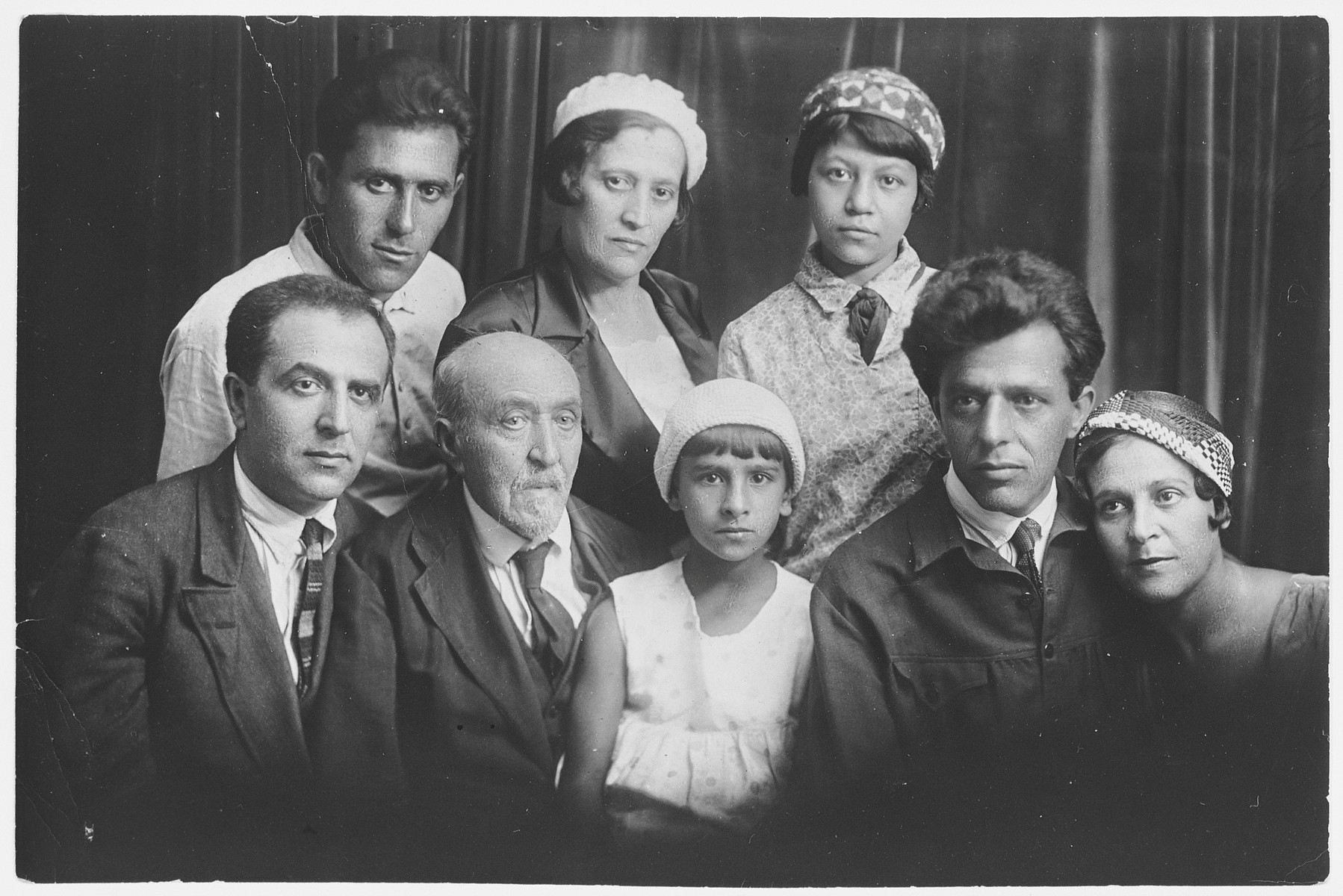 Studio portrait of the Pevsner family.

Pictured from left to right are: (front row): Yefim, Nonno, Marco, Nora, Khonia and Olya Pevsner.  (back row): Naum, Anya and the daughter of Khonia and Olga Pevsner.