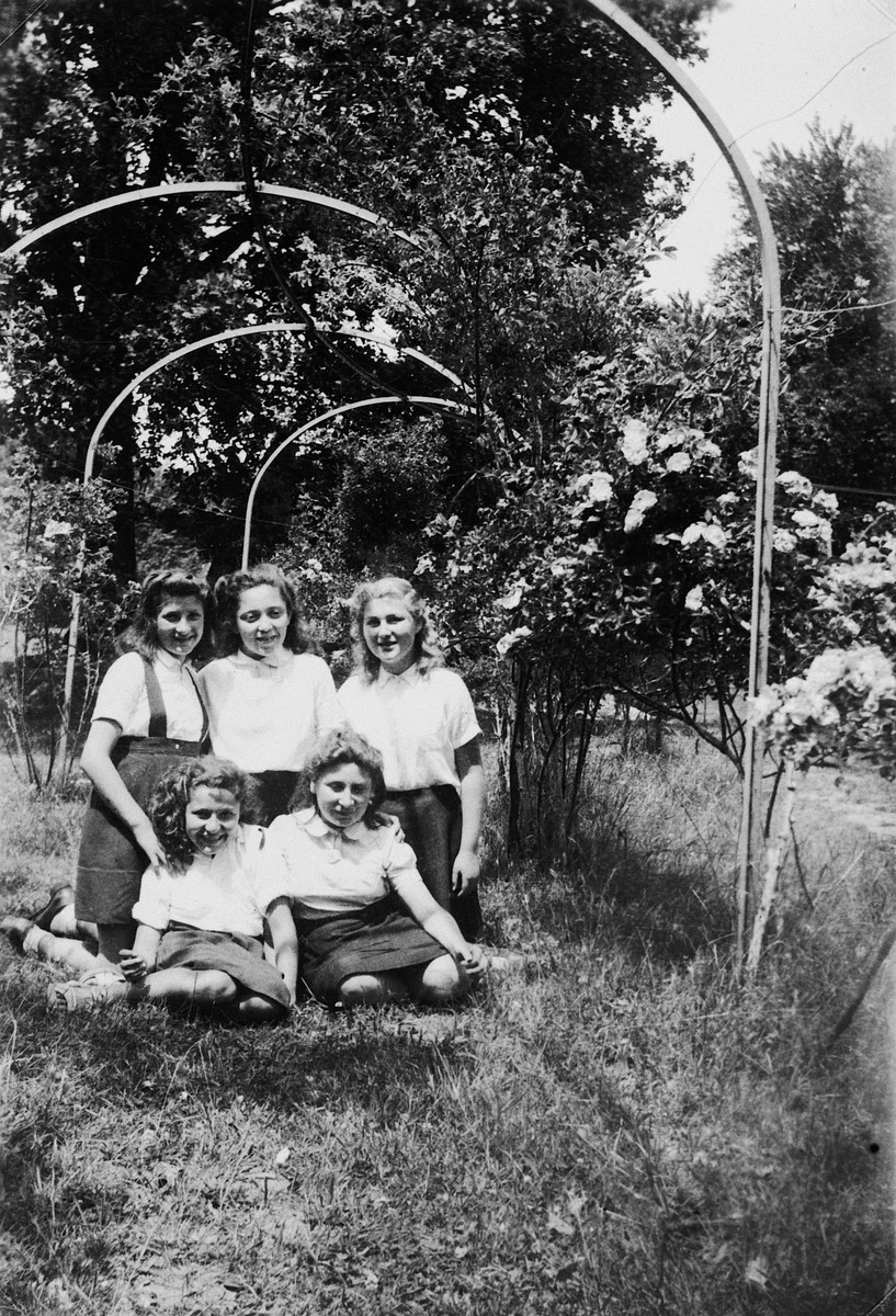 Teenage girls sit in the garden of the Le Couret children's home.

Among those pictured is Gisela Edel.