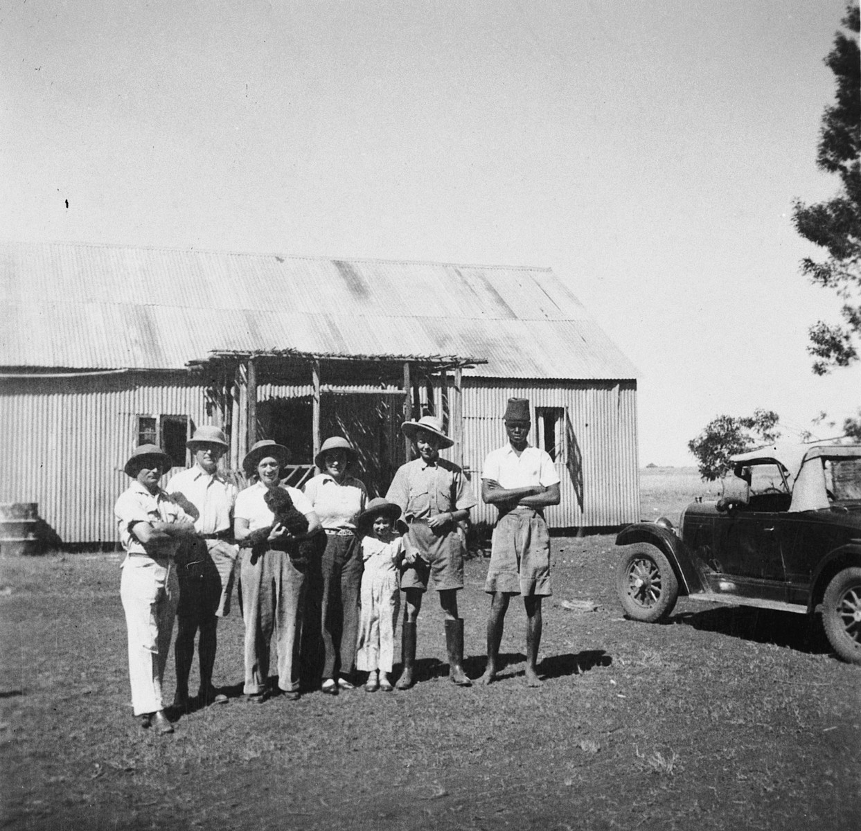Members of a Jewish refugee family pose with an African assistant on their farm in Kenya.

Pictured are members of the Zweig family.  Stefanie Zweig is third from the right.