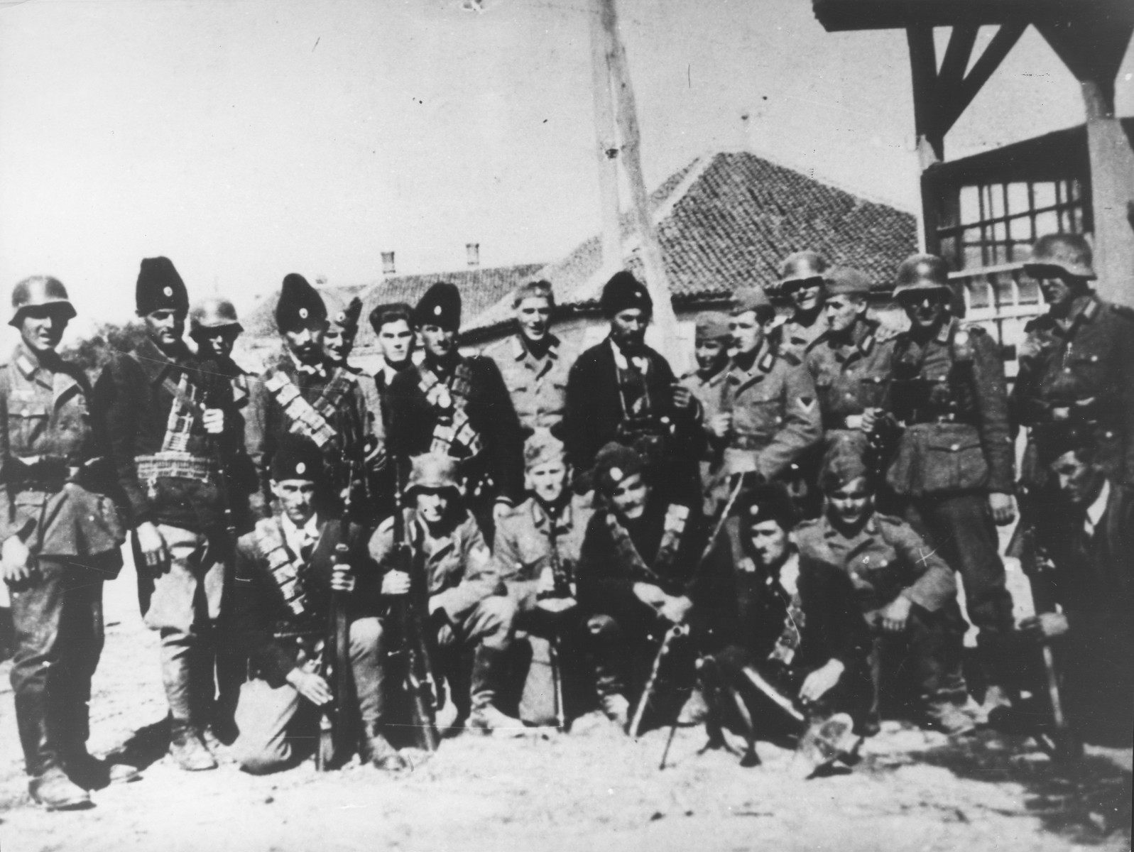 A group of Chetniks pose with German soldiers in an unidentified village in Serbia.