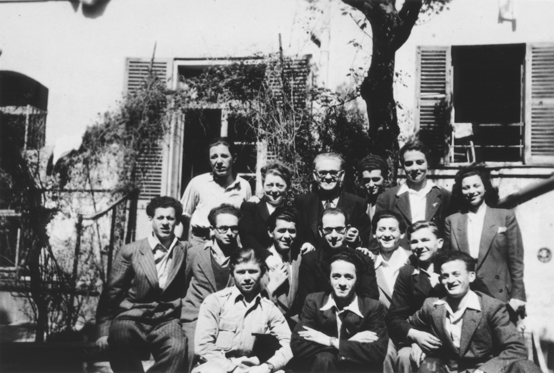 Group portrait of the staff and youth of the OSE children's home on the rue Rollin in Paris.

Pictured from left to right are: Front row: Joseph Magier, Gerson, Asher Greenberg.  Middle row: Lazer Greenberg, unidentified, Peretz Fogel, Joseph Szwarcberg and unidentified.  Top row: Willy Fogel, an elderly couple who brought food to the home, unidentified and Eddie Balter.