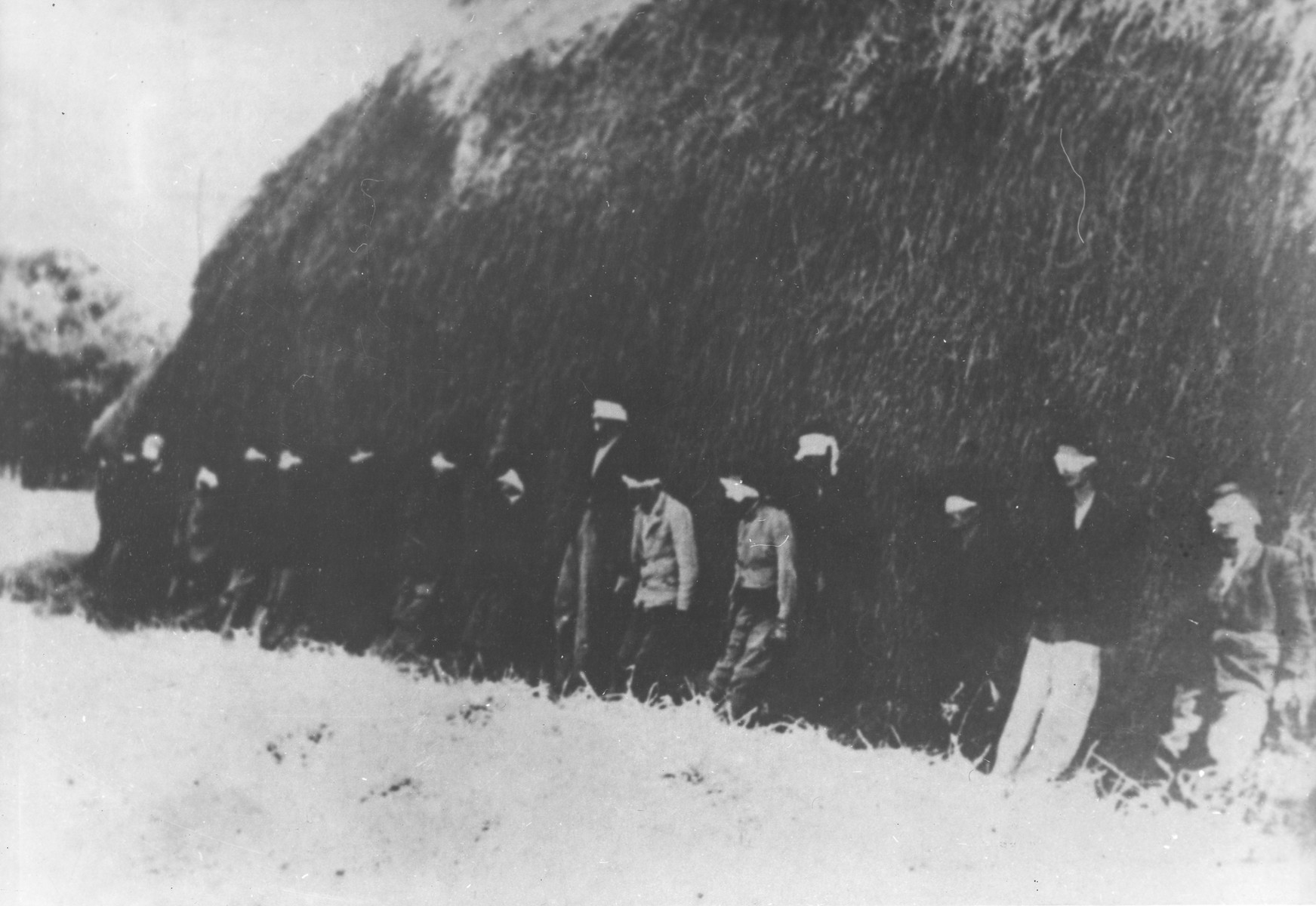 Sixteen blindfolded partisan youth await execution by German forces in Smederevska Palanka, Serbia.

A German soldier was widely reported to have been executed along with the partisans for refusing to take part in the action.  However, in actuality he died from wounds he suffered the previous day.