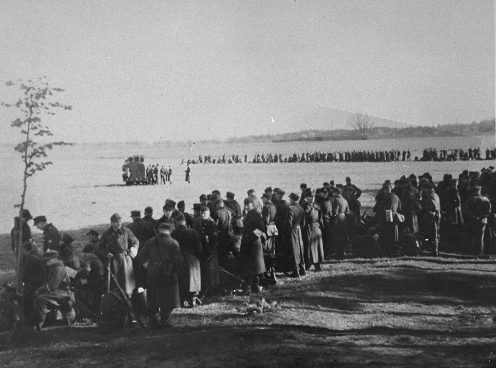 British liberators of Bergen-Belsen concentration camp prepare former SS guards and camp personnel for burying the corpses of prisoners killed in the camp.