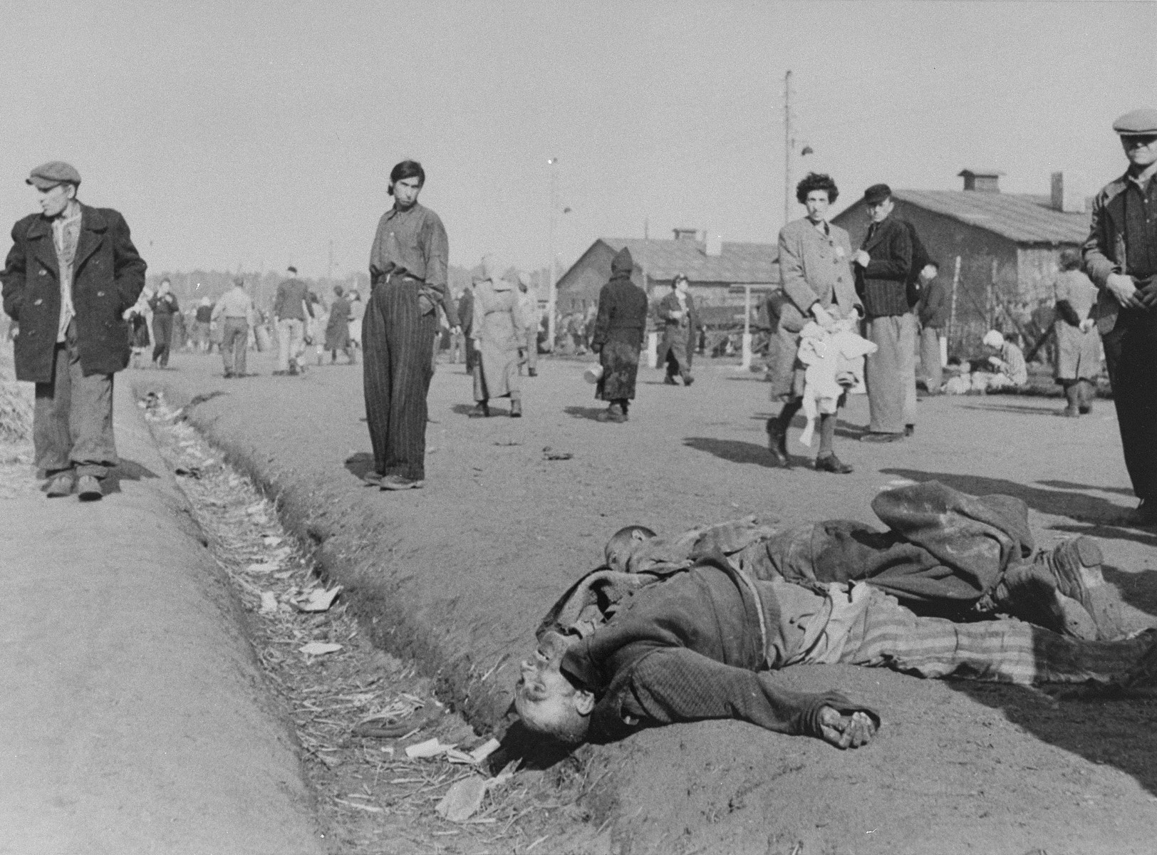 Corpses lying amongst survivors in Bergen-Belsen.