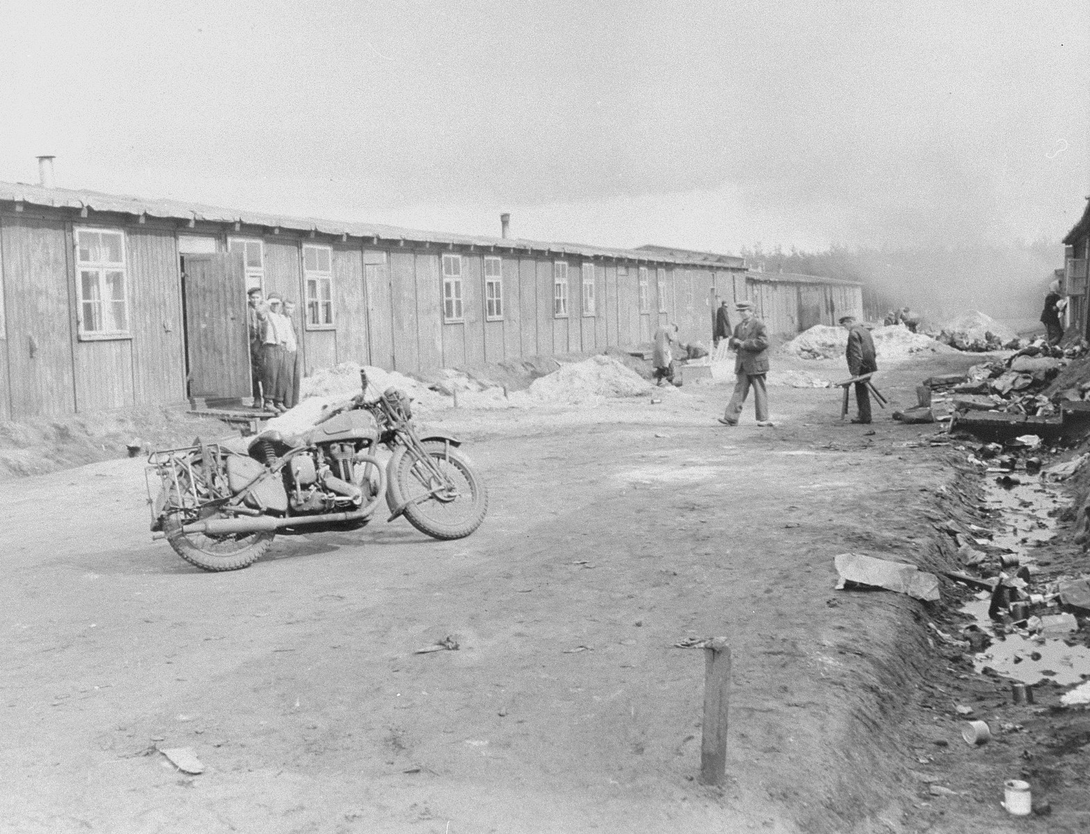 Survivors on a camp street in Bergen-Belsen.
