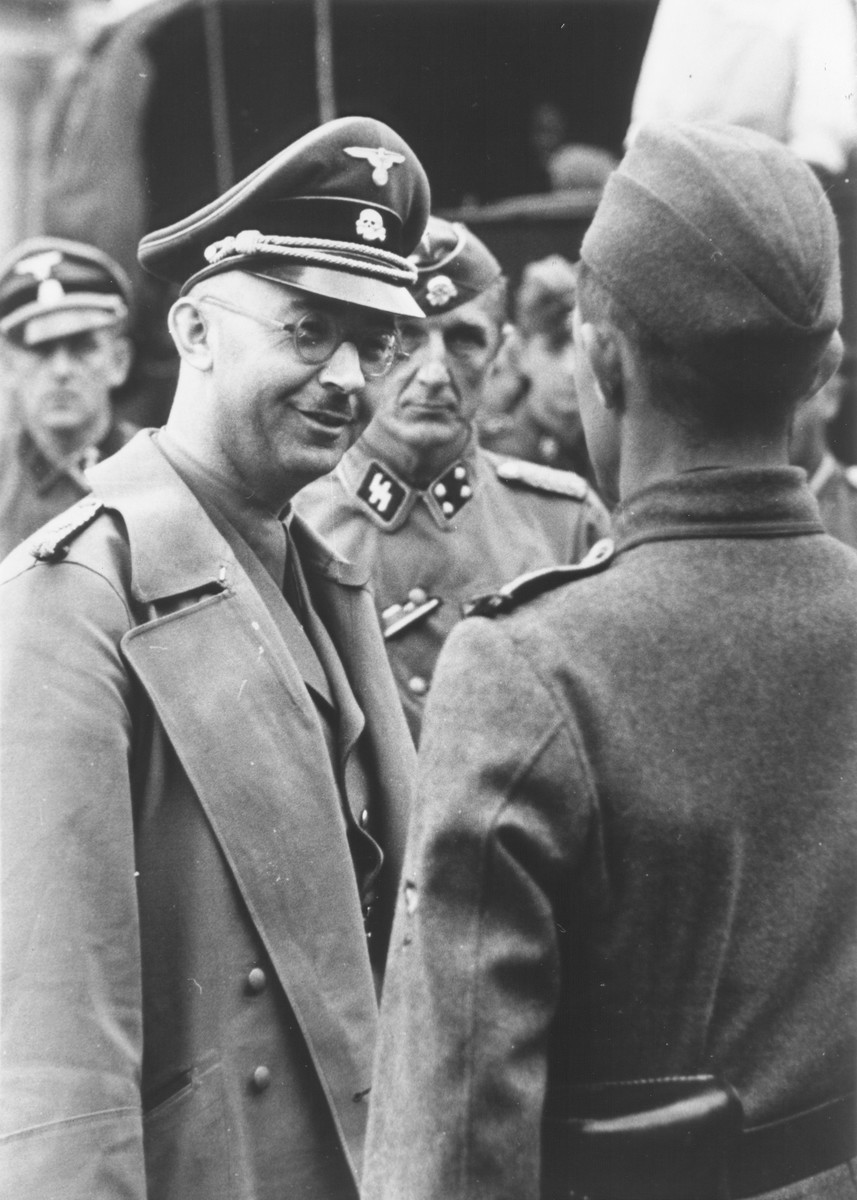 Reichsfuehrer-SS Heinrich Himmler converses with an officer. 

The inscriptoin on the back of the photograph reads, "Mein Lieber Puppi vom Pappi."