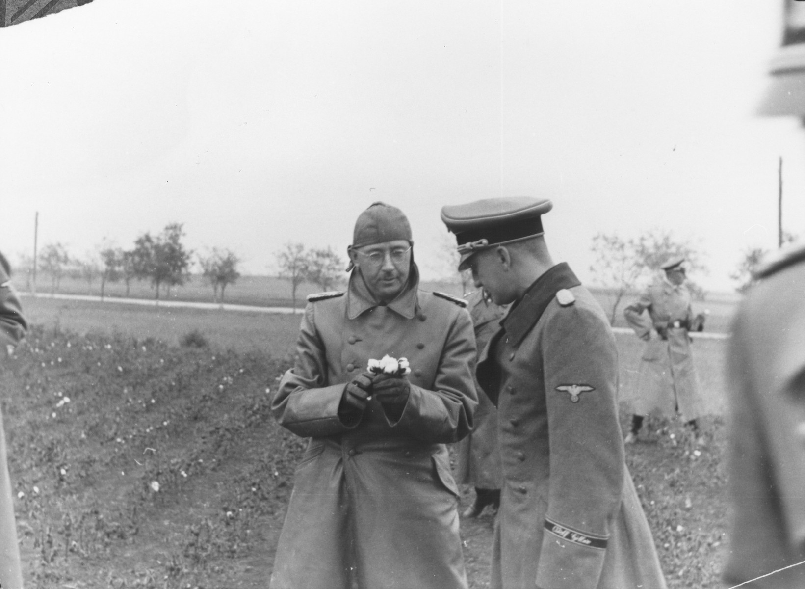 Reichsfuehrer-SS Heinrich Himmler inspects a cotton crop during a visit to the Crimea.

Standing next to Himmler is an officer of the Waffen SS-Division Leibstandarte Adolf Hitler.