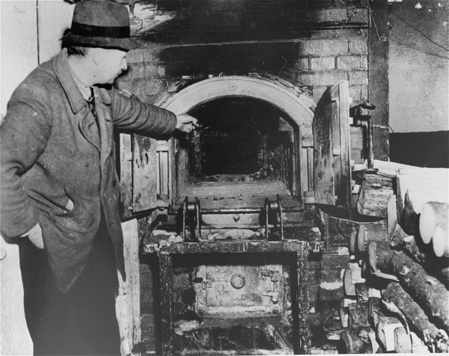 A French survivor shows the crematorium in Flossenbuerg to a photographer.