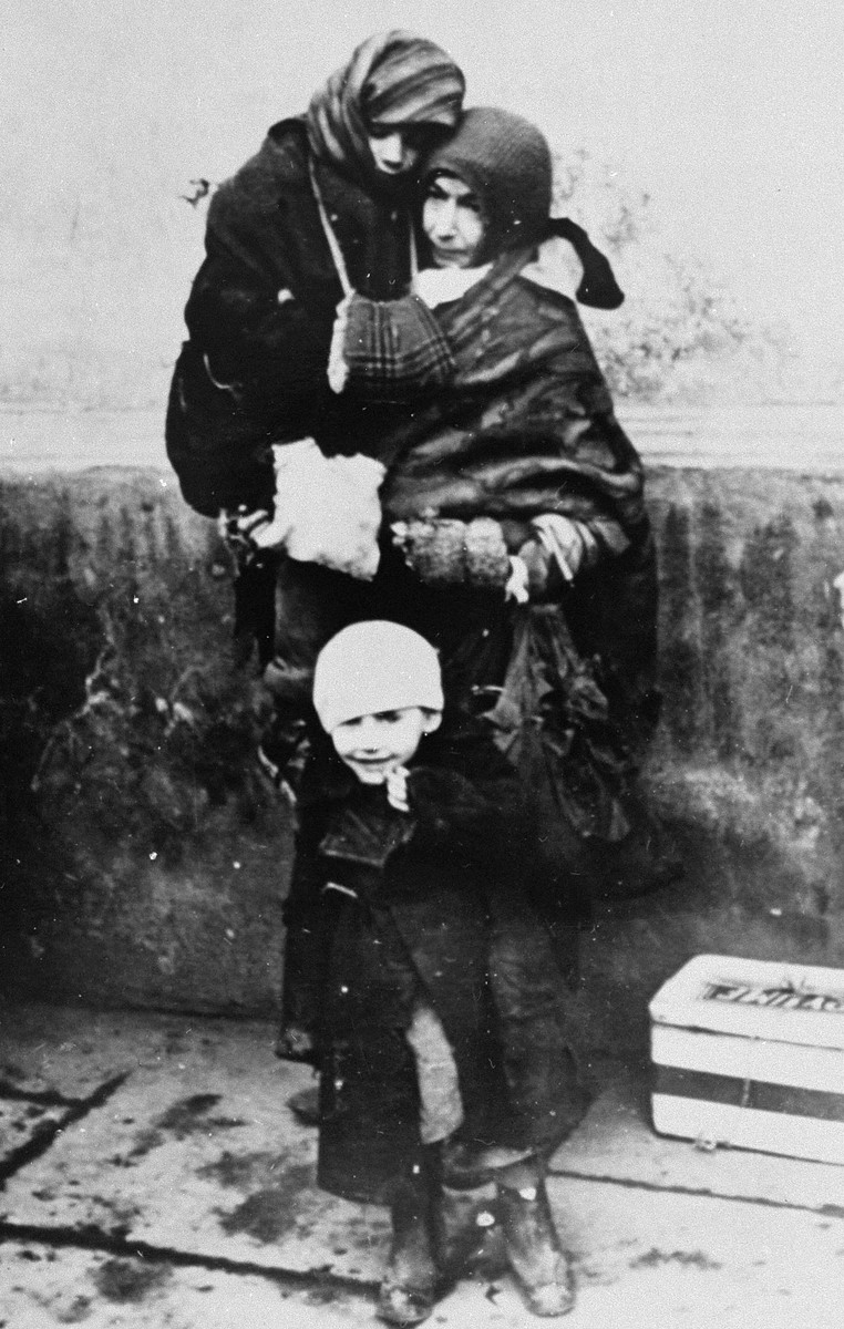 A Jewish woman and her two young children await deportation from the Krakow ghetto.