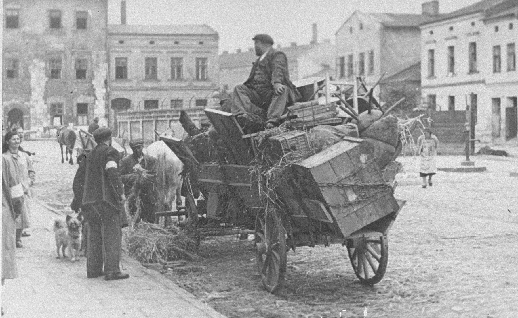 Forced to relocate to the Krakow ghetto, Jews move their belongings in horse-drawn wagons.