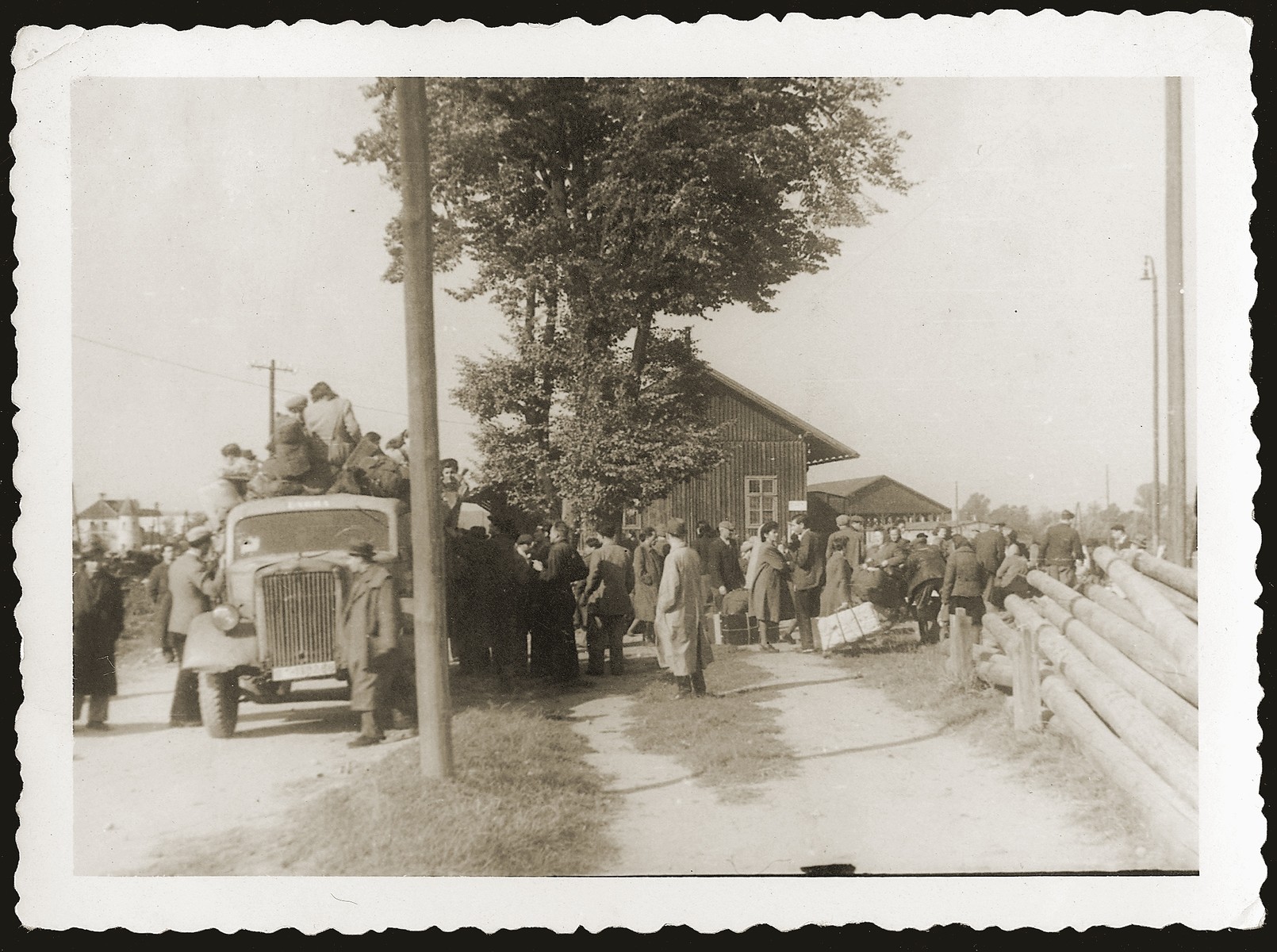 Newly arrived Jewish DPs from eastern Europe are gathered near the Enns River in Austria.  They will be taken by truck to nearby displaced persons camps after a second transport arrives from Vienna.