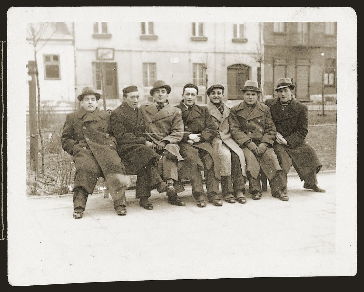 A group of young men sits on an outdoor bench in Czeladz.

Lazar Heida is pictured second from the left.