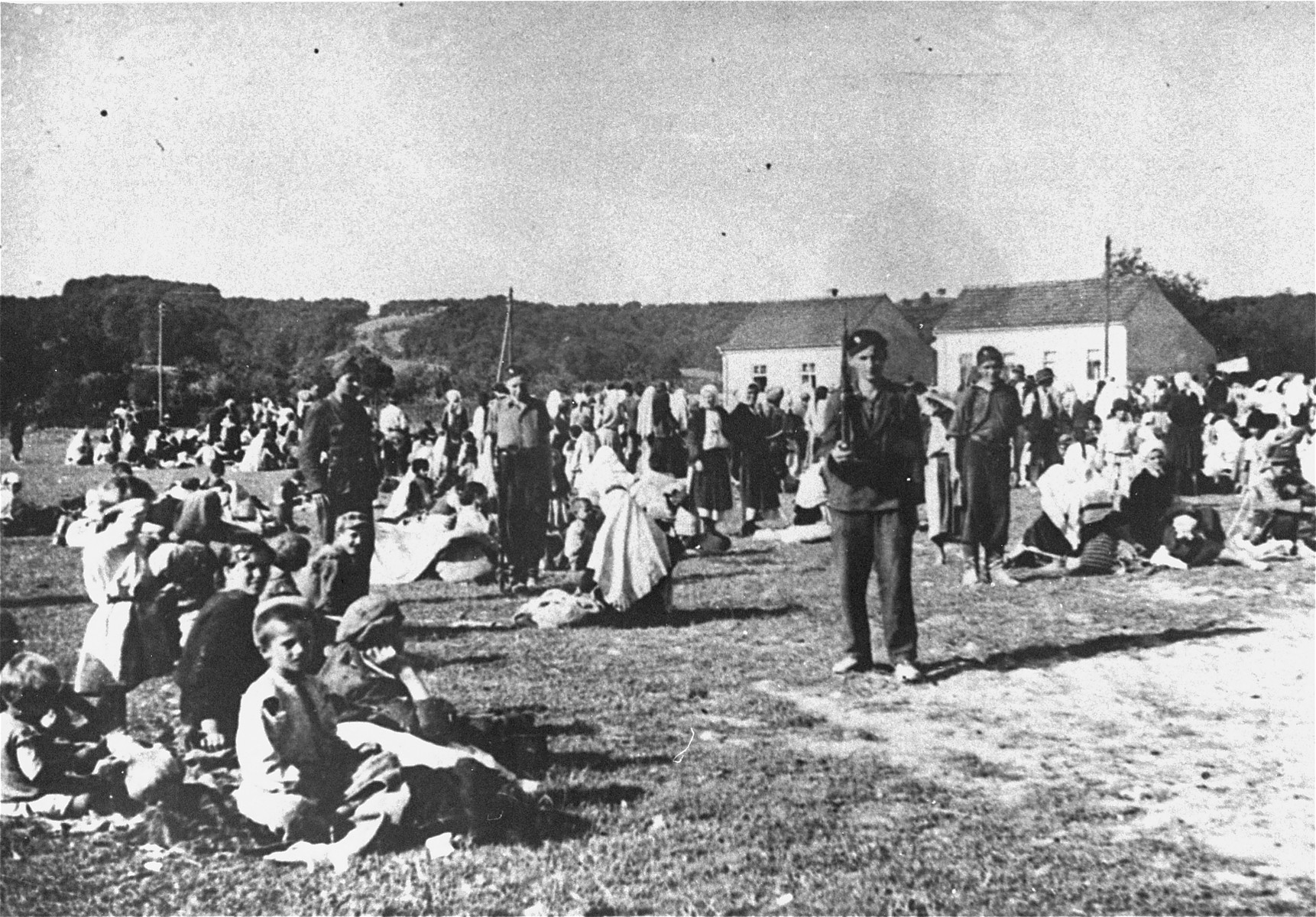 Ustasa militia guard a group of Serbian women and children from the Kozara region, who are imprisoned in the Daruvar concentration camp.