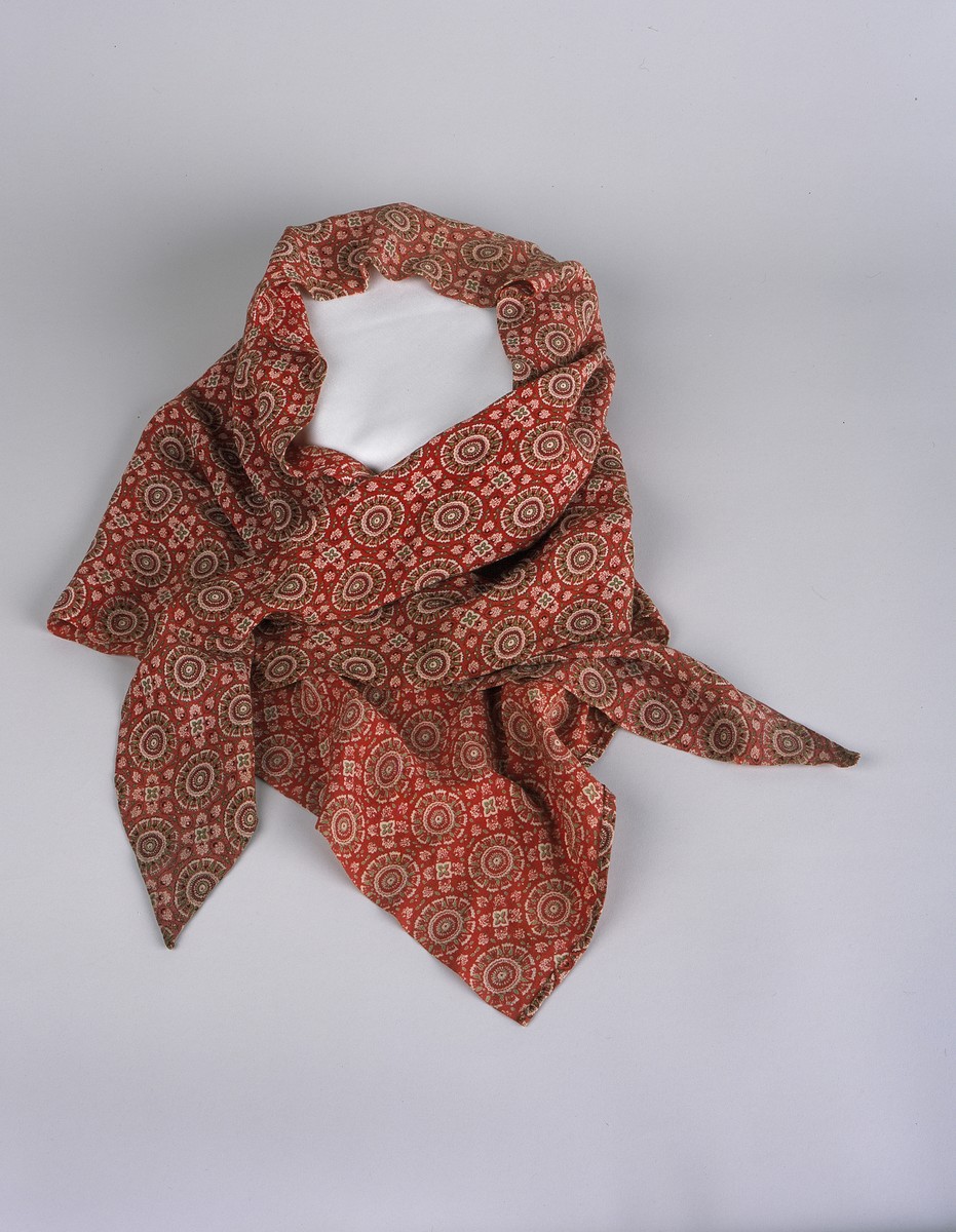A red, green, and white scarf that had belonged to her mother, Frieda Fromm, that Ruth Abraham used to cover her newborn infant while in hiding.