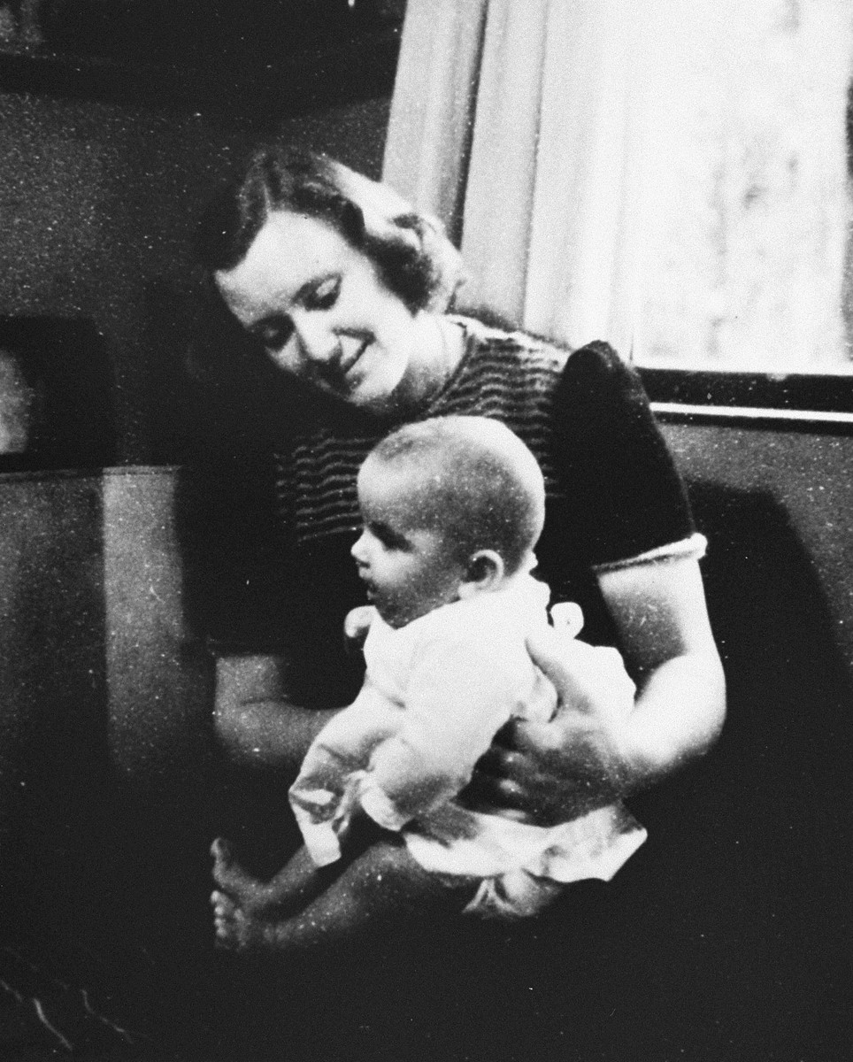 Dutch rescuer Marion Pritchard poses with the Jewish infant, Erica Polak, whom she is hiding.