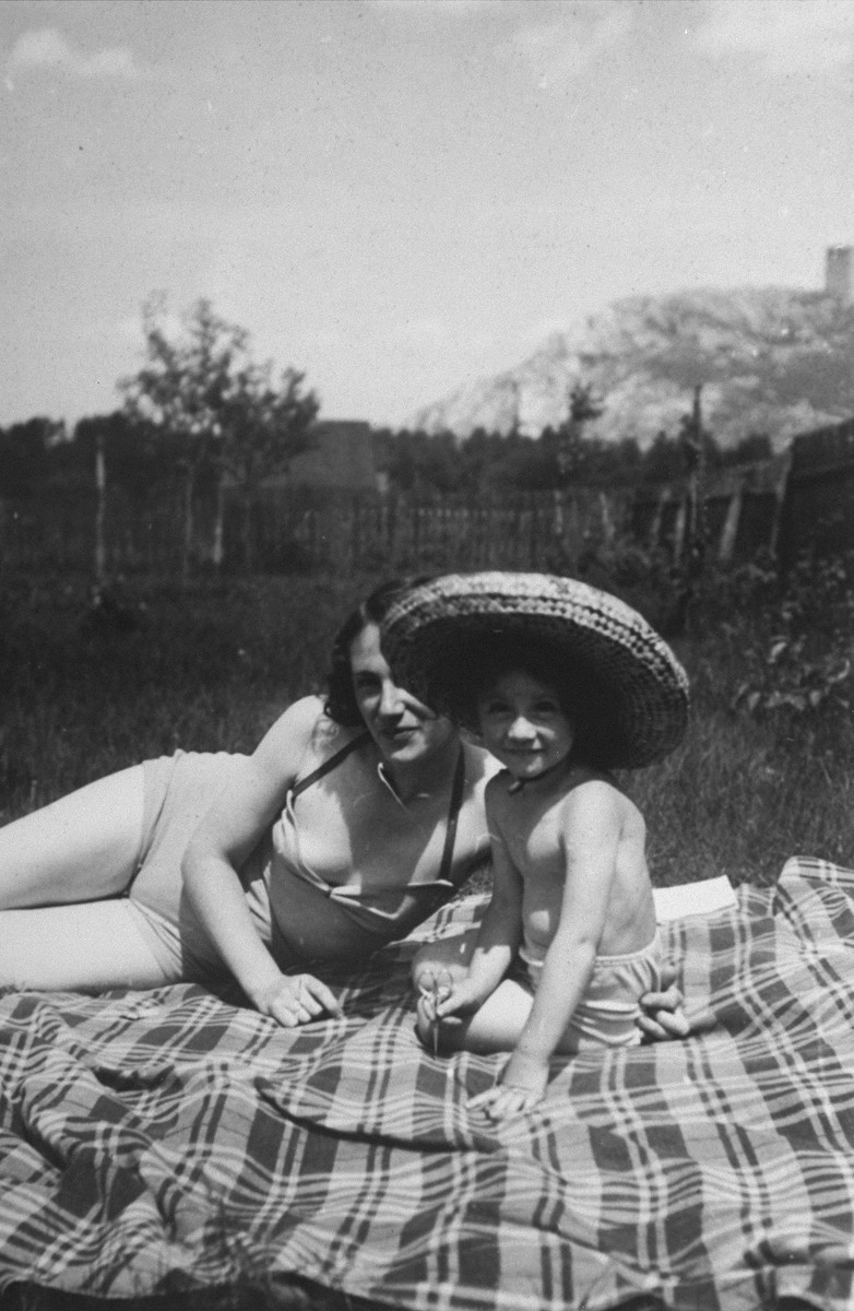Maria Minc Morgenstern sunbathes with one of her twin daughters in the yard of their home while living in hiding under false papers.