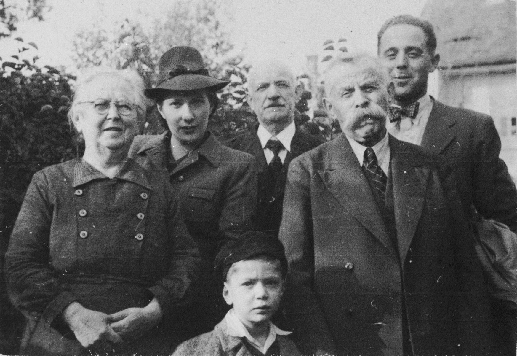 Julius and Fanny Goldstein pose with their son, Bohus, and members of his family.  

Pictured from left to right are Fanny, Wilma Goldstein, Michael, Max Redlich (Wilma's father), Julius and Bohus.  Bohus and Wilma (Redlich) Goldstein had two children, Eva and Michael.  The family lived in Olomouc, where Bohus worked for the Prague autoworks.  They all perished during the war.