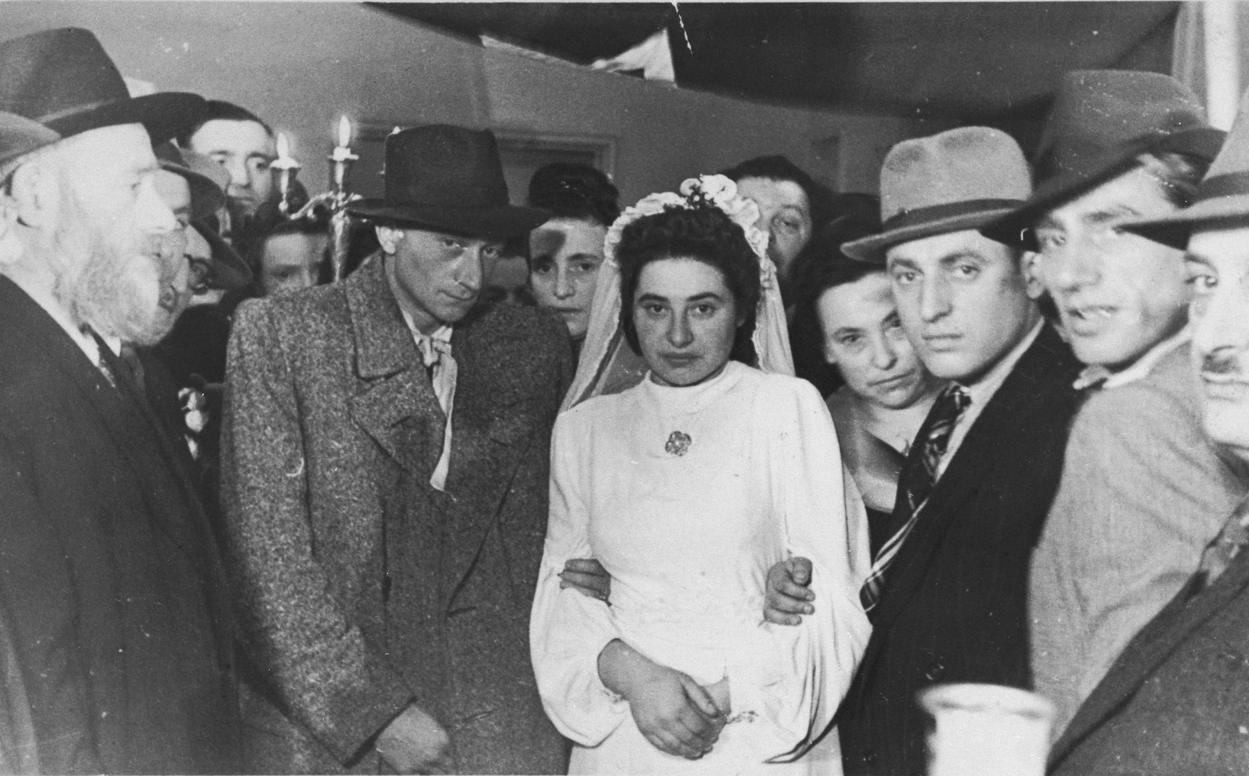 Jewish DPs are wed in a ceremony in Heidelberg, Germany.

Pictured are the bride and groom, Toby and Bernard Weitschner.  Standing next to them on the right are Chava and Izak Lachter.