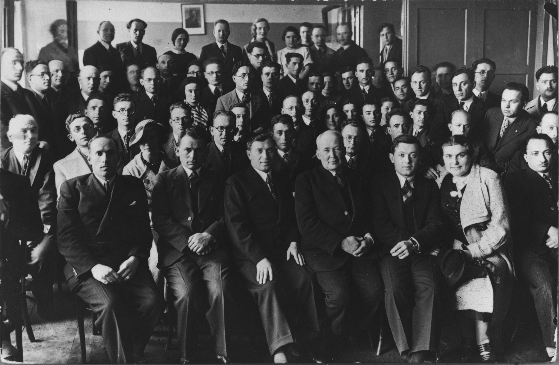 Group portrait of Jewish Tarbut school teachers at a national convention.  

Among those pictured is Ralph Denishevsky (front row, left).