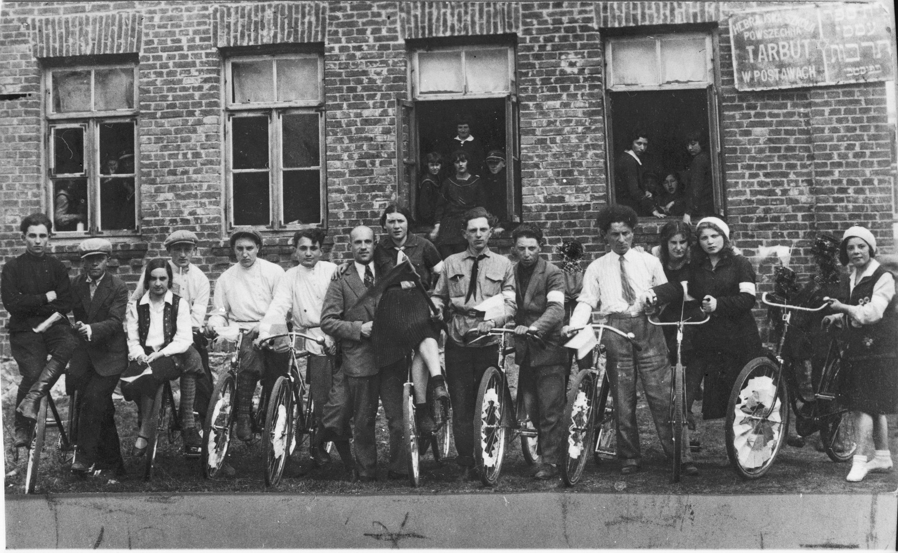Group portrait of students and teachers at the Hebrew language Tarbut school in Postawy with their bicycles.  

Among those pictured is Ralph Denishevsky (seventh from the left).