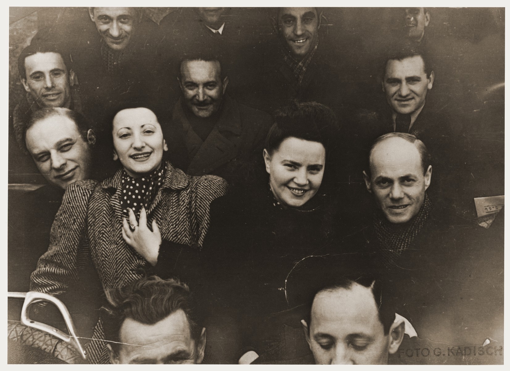 Members of the X-Concentration Camp Orchestra on their bus during a concert tour.   Henia Durmashkin is on the left.  Her sister, Fania Durmashkin Becker is beside her.  Fania's husband, Max Becker is in the back, second from the right.

Henia Durmashkin was born in Vilna in 1926.  She is the daughter of Sonia and Akiva Durmashkin, who was a highly-regarded musician, composer, and the conductor of the choir in the City Temple of Vilna.  The youngest Durmashkin, Henia had a sister, Fania, a trained pianist, and a brother, Wolf, a child prodigy and later, a renowned conductor.  Henia's vocal talent was discovered early.  While in the second grade at the Tarbut Gymnasium, Henia performed songs for Hayyim Bialik at a program honoring his visit.  The songs were Bialik's poems put to music composed by Akiva Durmashkin.  Henia went on to study at the Conservatory of Music in Vilna, and in 1940, she was the only Jew accepted to the City Choir of Vilna.  In the summer of 1941, Henia and her family were moved into the Vilna Ghetto, and soon after, Akiva was arrested and deported during an action.  In 1942, the Hebrew Ghetto Choir of Vilna gave its first concert under the direction of Wolf Durmashkin with Henia and Fania both participating.  The Vilna Ghetto was liquidated in September 1943.  Sonia Durmashkin was too frail to be selected for labor.  Wolf was deported to labor camps in Estonia.  Henia and Fania were sent to Riga, and for the next two years, to a number of other labor camps.  In one camp, Henia met Abrasha Stupel, a violinist.  Henia and Fania were liberated on a death march from Dachau, May 1, 1945, by the U.S. Army.  Soon after, Henia was invited by Abrasha Stupel to join a group of musicians gathered at St. Ottilien DP Hospital.  They called themselves the "St. Ottilien Orchestra," the "X-Concentration Camp Orchestra," and finally the "Representative Orchestra of the She'erit Ha-Peletah."  In 1946, the orchestra relocated from St. Ottilien to Fuerstenfeldbruck.  They were employed by the JDC, UNRRA, and IRO to play at DP camps throughout the U.S. and British zones of Germany.  During her travels, Henia learned that her beloved brother, Wolf Durmashkin, had been killed along with other inmates of Klooga, one hour before the liberation of the camp.  In 1948, Leonard Bernstein traveled to Germany to conduct the Munich Symphony Orchestra.  In May, in a Munich theatre, he accompanied Henia for two Hebrew songs. Henia Durmashkin immigrated to the United States, where she and her sister, Fania, continued to perform.