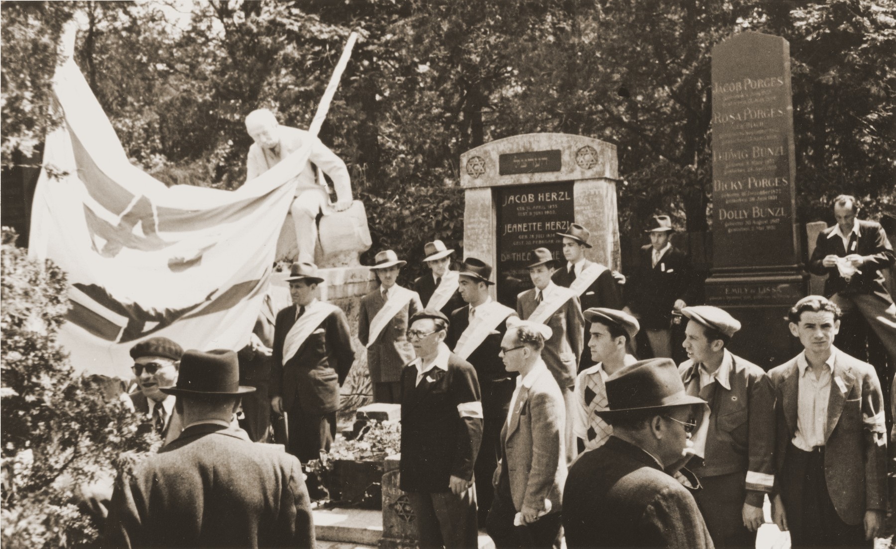 Members of the Betar Zionist youth movement demonstrate against British policy in Palestine at the tomb of Theodor Herzl in the Jewish cemetery in Vienna.  

The demonstration was timed to coincide with the visit of the United Nations Special Commission on Palestine to Vienna.
