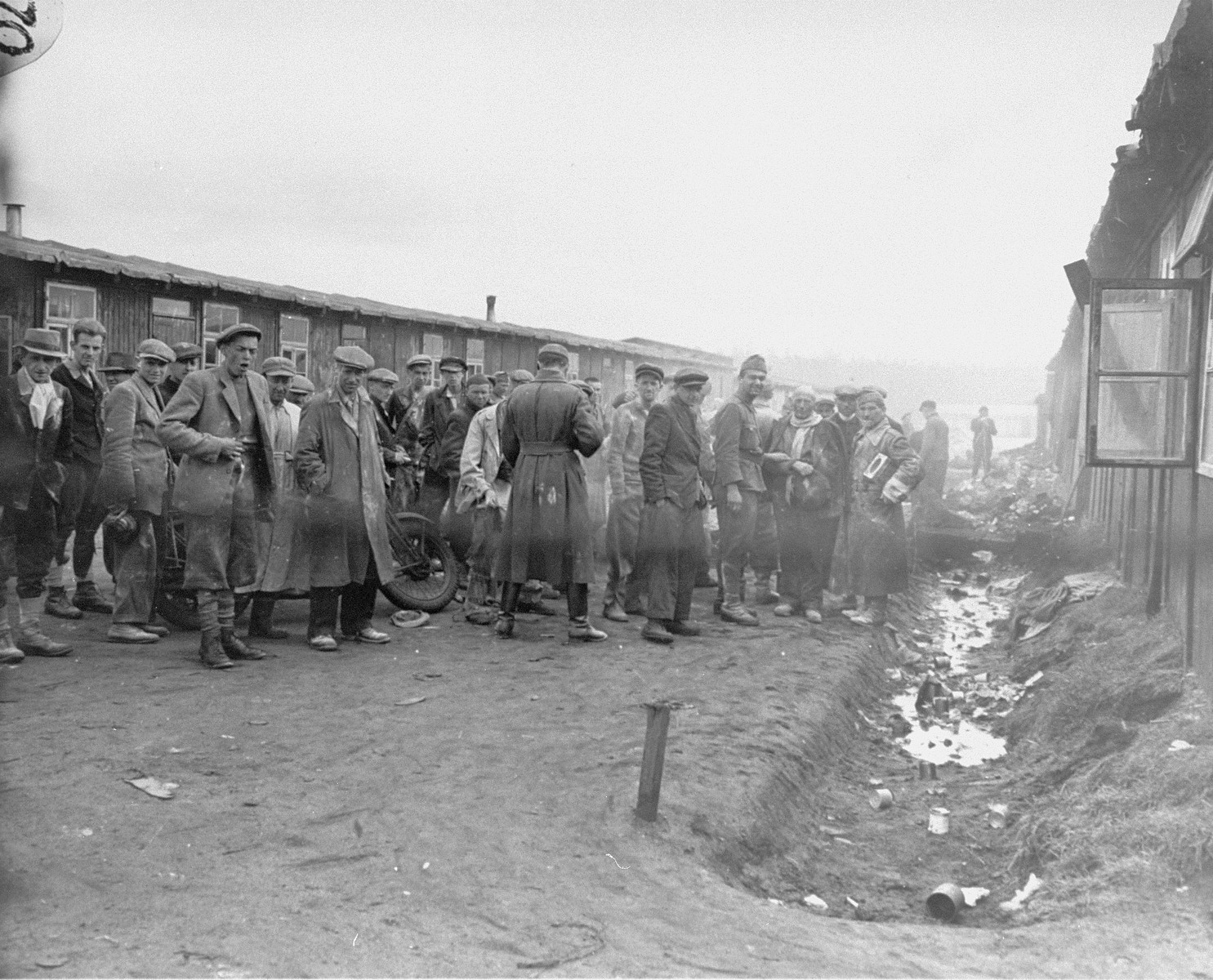 Unidentified soldiers dusting survivors in Bergen Belsen with DDT powder to halt the spread of Typhus.