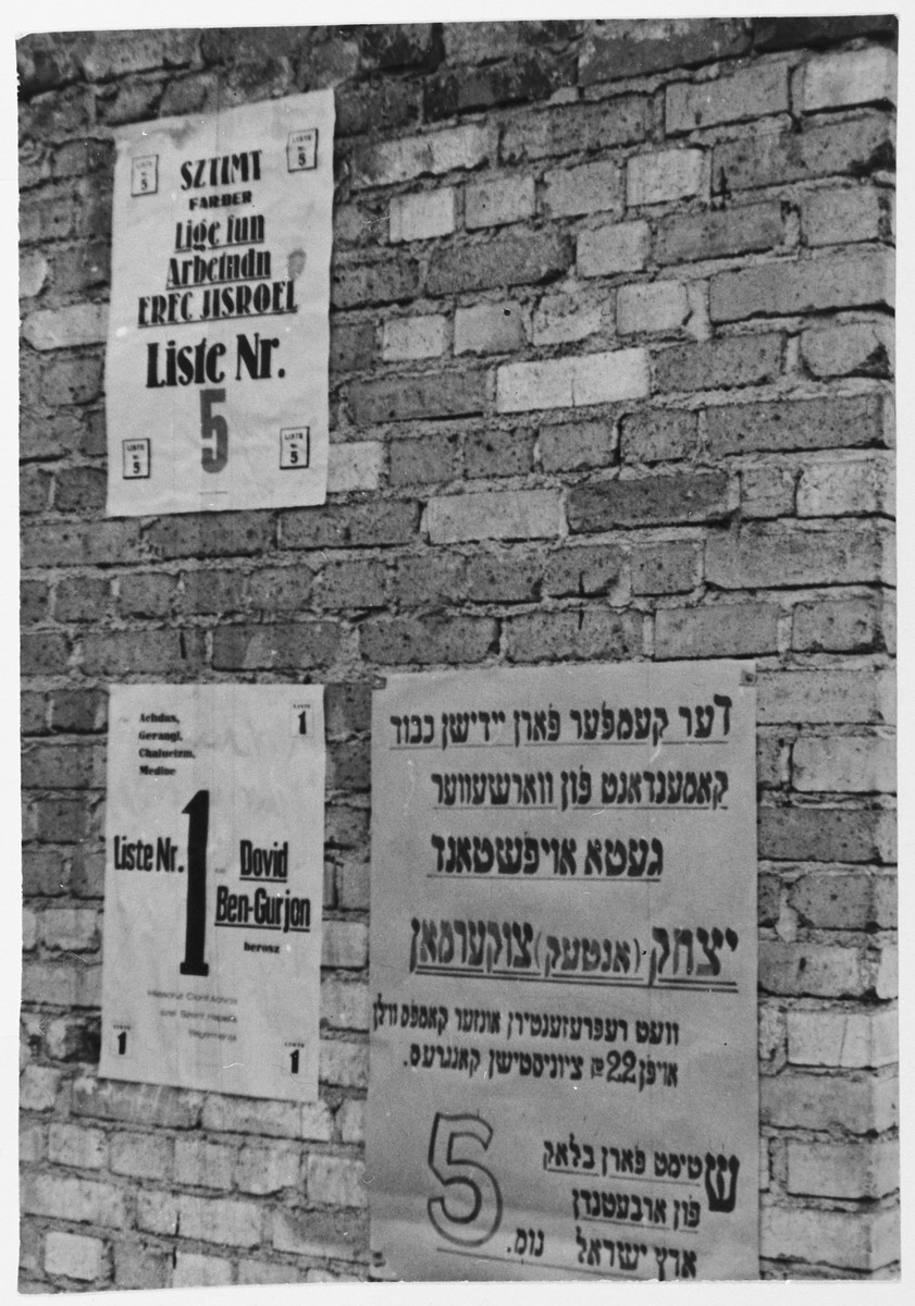 Election posters on a wall in the Zeilsheim displaced persons' camp.

List one is headed by David Ben-Gurion and list five by Antek Zuckerman.