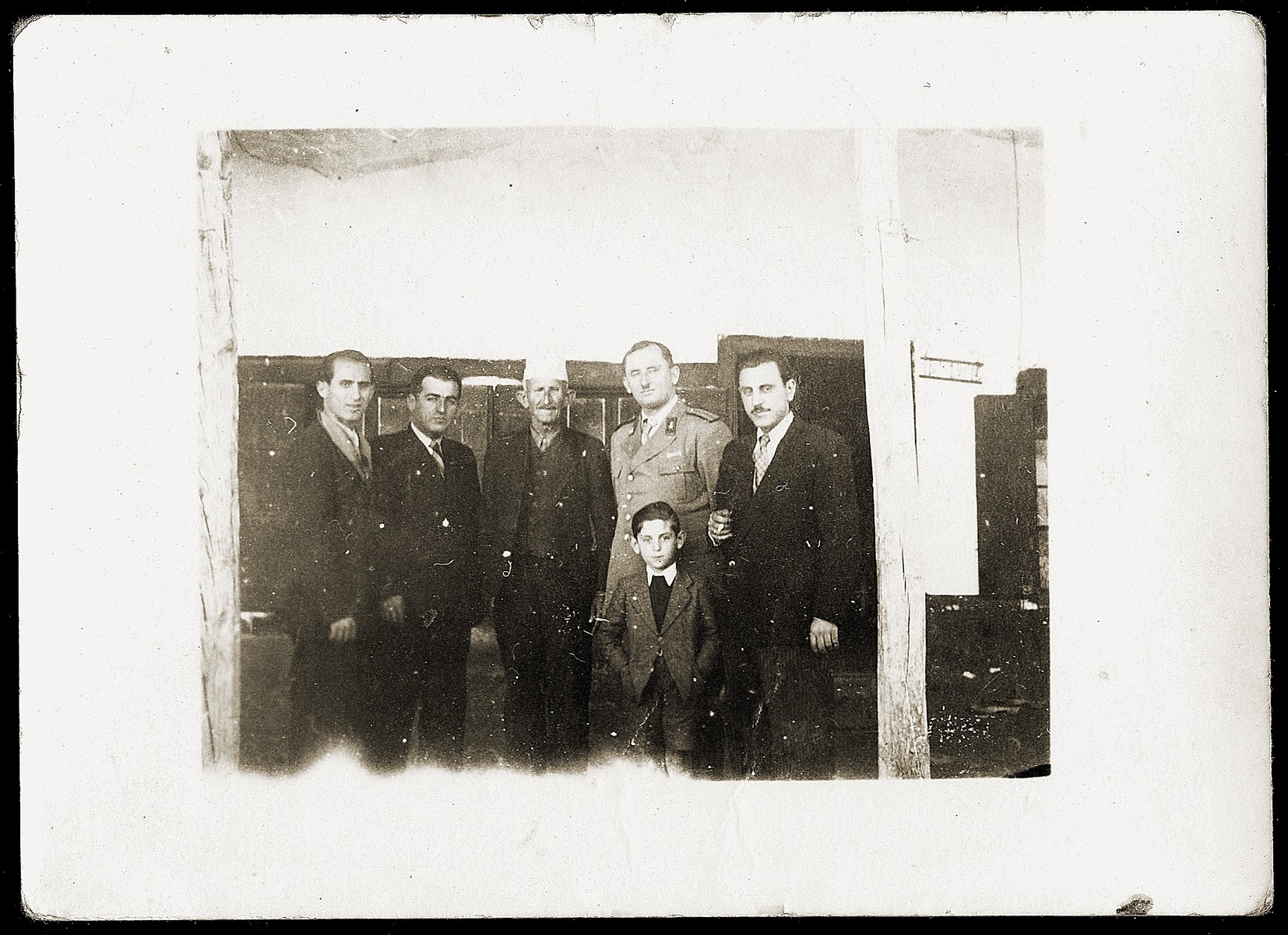 Mosa Mandil (right) and his son Gavra pose with Kavaja town officials, including the mayor and chief of police at the police station in Kavaja, where they had to register every day.