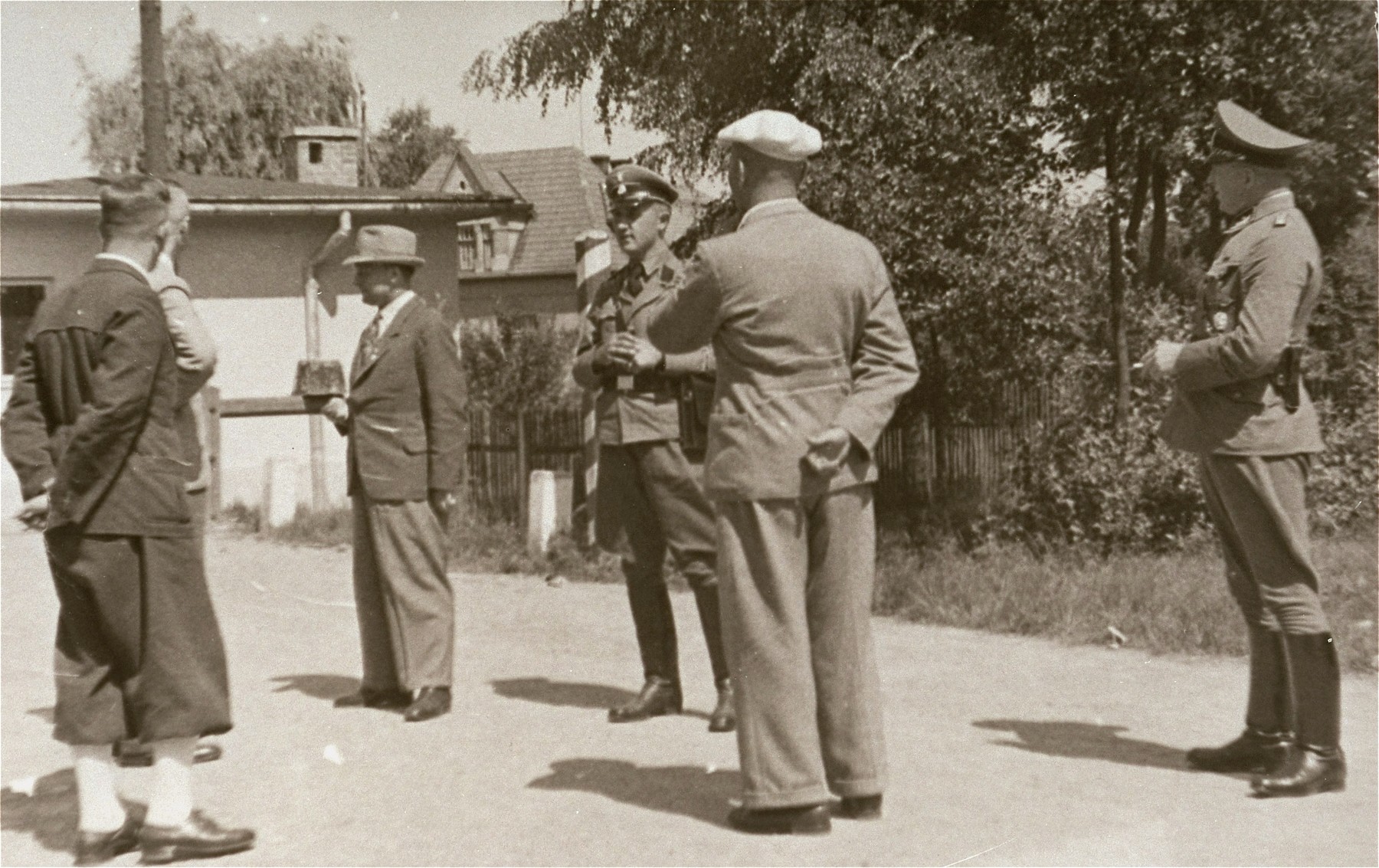 [Probably, SD officers questioning the ethnic German (Volksdeutsche) inhabitants of a Polish town.]  

It was standard practice during the Polish campaign for the SD and German military to question local ethnic Germans for information pertaining to Poles considered Deutschfeindlich, or "hostile to Germans."  Poles and Jews named during such interviews were then arrested as suspected opponents and either shot or sent to the rear for internment. 

One image of Einsatzgruppen activities in Poland in 1939, found by Joseph Igra after the war, in a an album in an apartment in Sosnowiec.