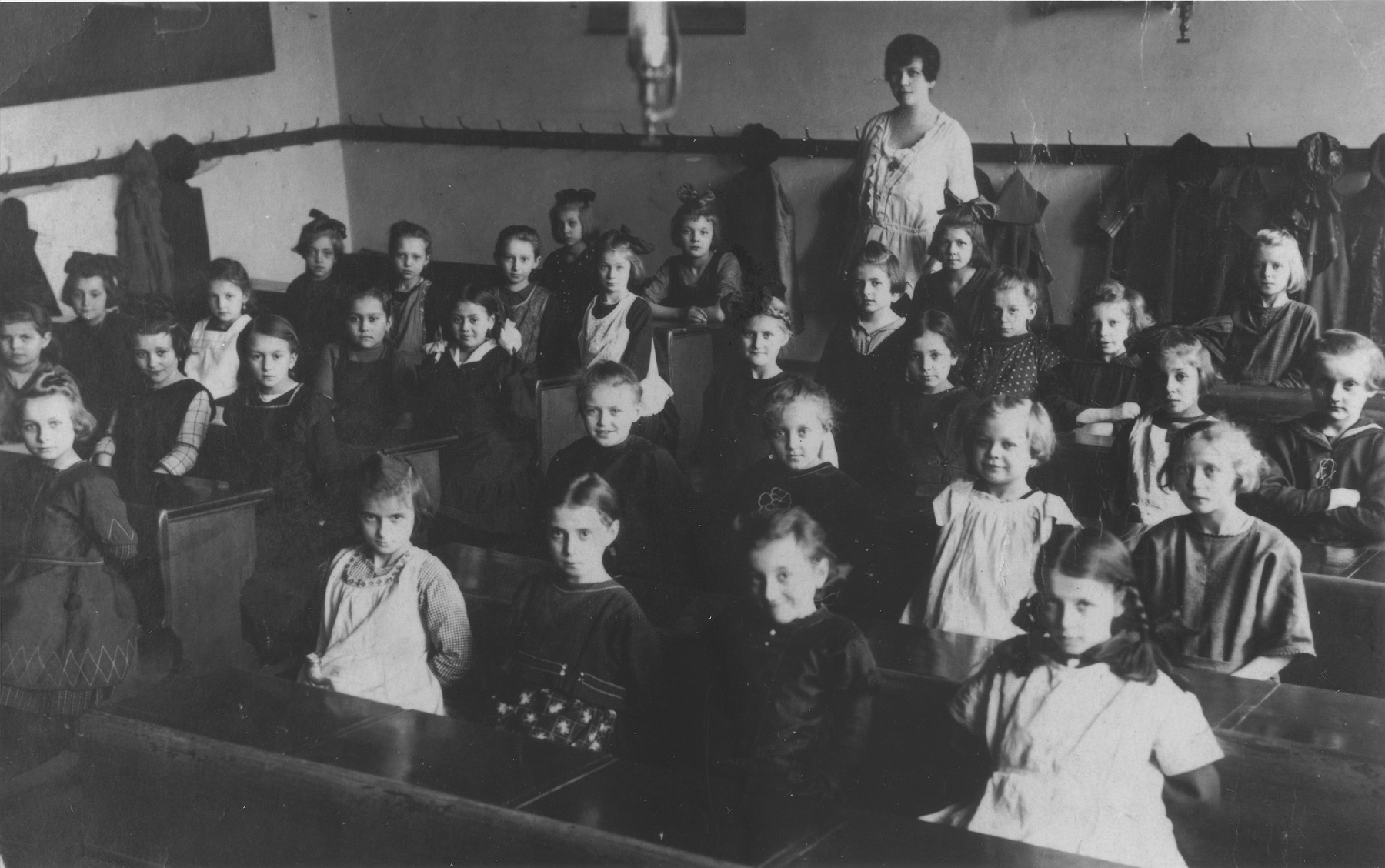 Pupils pose with their teacher in a classroom at an elementary school in Prague.

Among those pictured are Marta Mautnerova (third row from the front, at the far left).