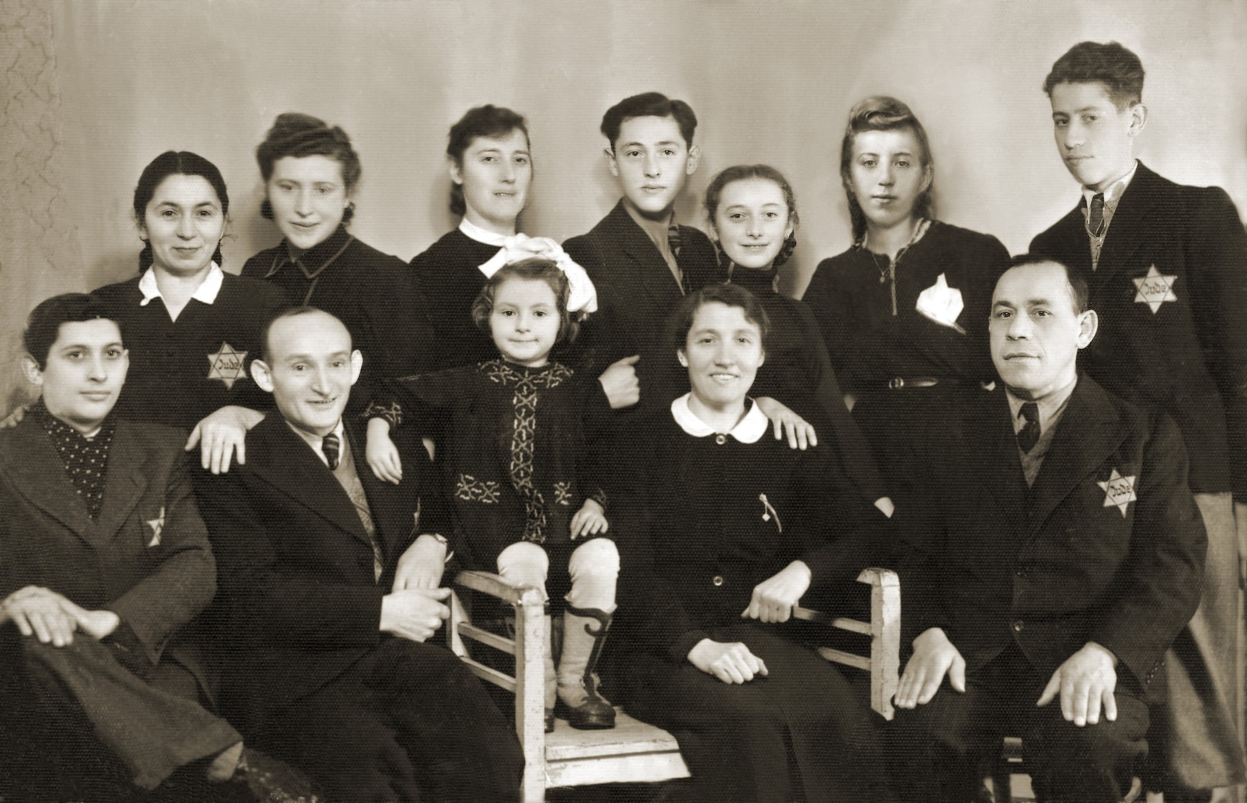 Group portrait of members of the extended Gipsman family in the Bedzin ghetto.

Pictured in the back row, from left to right are: Lea and Chawa Gipsman; Chaja Gitla Gipsman; Natan Gipsman; Maniusia Gipsman; Regina Fajerman; and Maks Zylbersztajn.  Seated in the front row, from left to right are: Herman Zylbersztajn; Wolf Gipsman; Dina Gipsman; Sara Zylbersztajn; and Moryc Zylbersztajn.