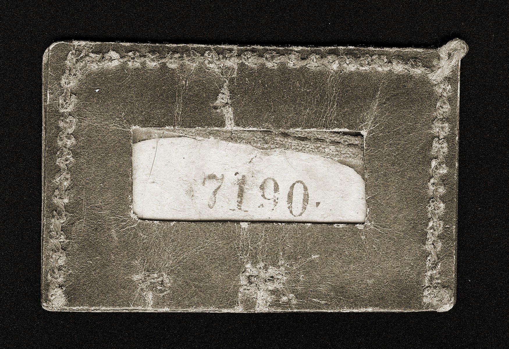 An identification tag issued to Gina Tabaczynska, when she was detained with other employees of the Schultz & Co. factory in the Warsaw ghetto in the summer of 1942.  Those who held these numbers were presumed to be exempt from deportation.
