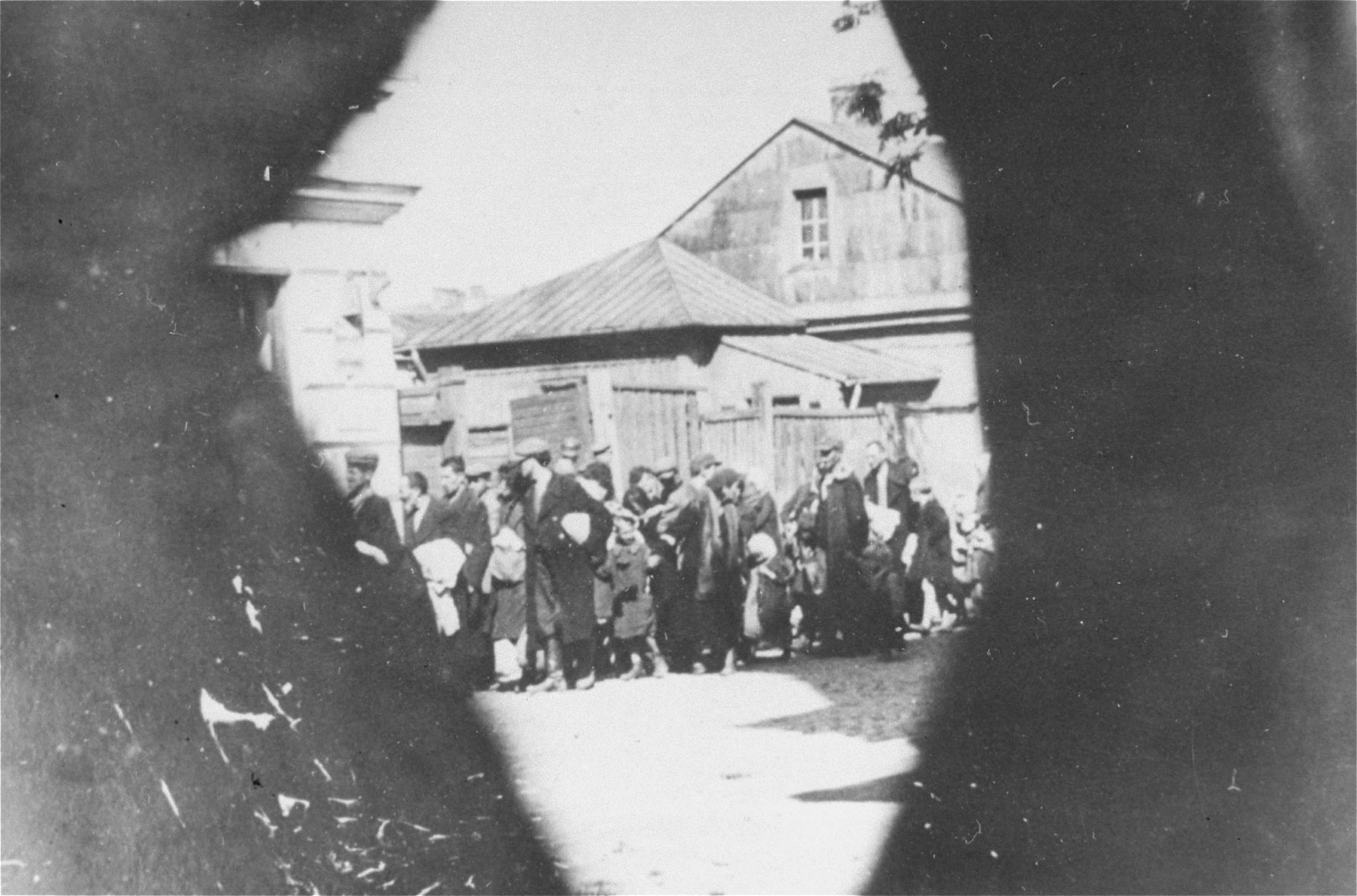 Jews are led through the streets of the town on their way to the railroad station during a deportation action from the Siedlce ghetto.

One of a series of clandestine photographs taken by a member of the AK (Polish Home Army) underground.