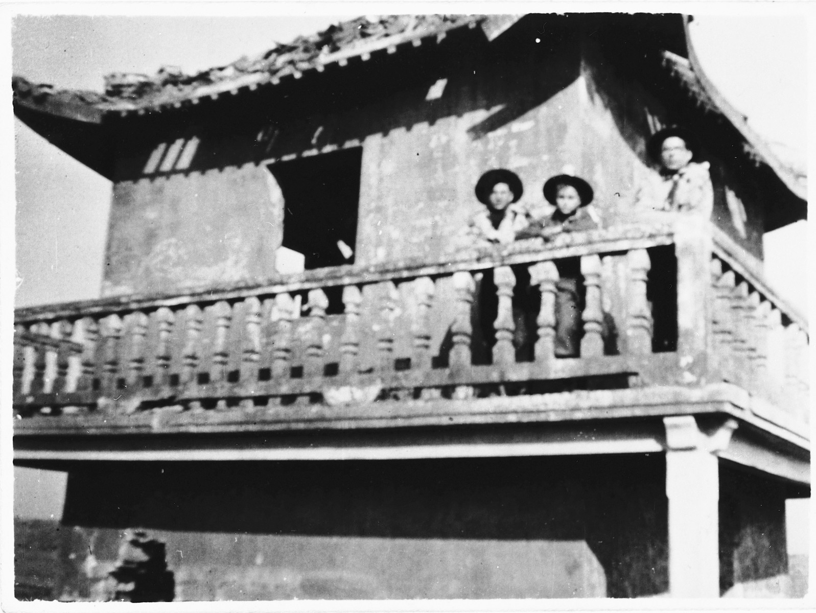 Three members of Betar pose on the balcony of a pagoda in the Hongkew ghetto.