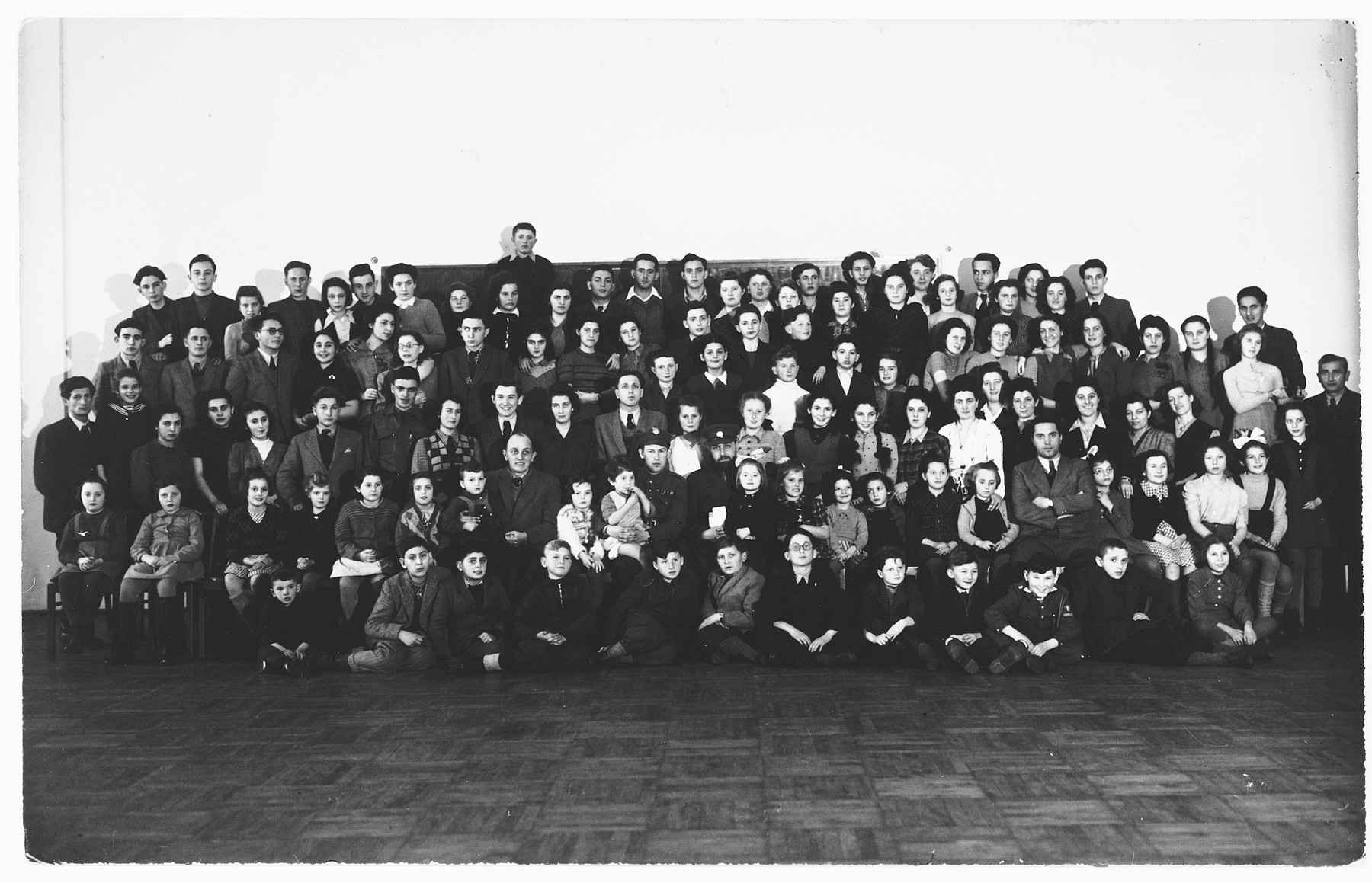 Group portrait of Jewish orphans whom Rabbi Solomon Schoenfeld gathered together to take to England from Poland.

Among those pictured is 14 year old Izio Degenszajn,  standing in the back row extreme left.  He is a survivor of the Warsaw Ghetto. Also pictured are Bianka Rozenman and her cousin Gabriel Zakrzewski.