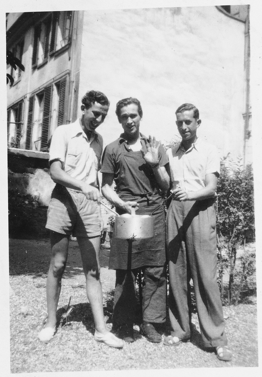 Three Jewish teenagers pose with a metal pot outside the rue Rollin youth home in Paris.

Pictured from left to right are: Lutz Scheucher, Alex Treuherz and Ernst Nieves.