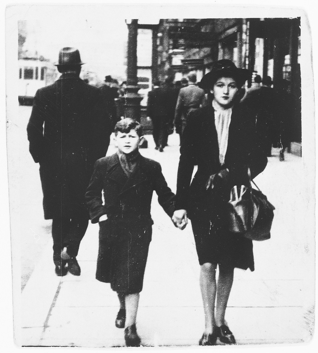 A Jewish brother and sister walk along a street in Brussels, Belgium.

Pictured are Henri and Clara.  This is Henri's last photograph of his sister prior to her arrest and deportation.
