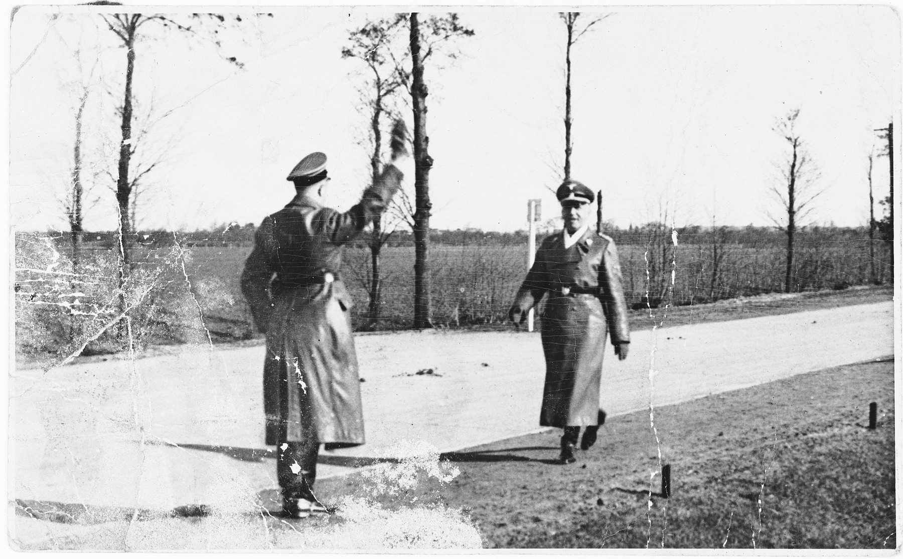 Two SS officers greet each other in the Dachau concentration camp.

Pictured is SS-Obersturmbannfuehrer (Lieutenant Colonel) Martin Weiss (1905-?), commandant of Majdanek from September 1943 to May 1944.