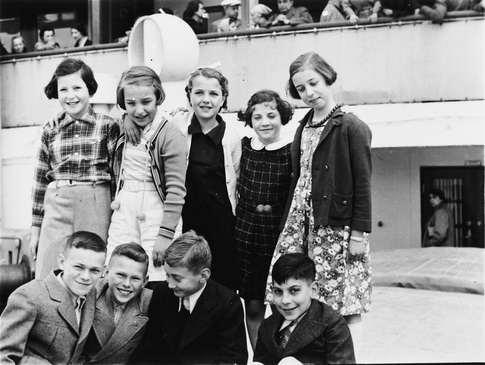 Group portrait of Jewish refugee children on board the St. Louis. 

Among those pictured are Evelyn Klein (back row, center), Herbert Karliner (front row, left), Walter Karliner (front row, second from the left), Eric Stein (front row, second from the right), and Harry Fuld (font row, far right).