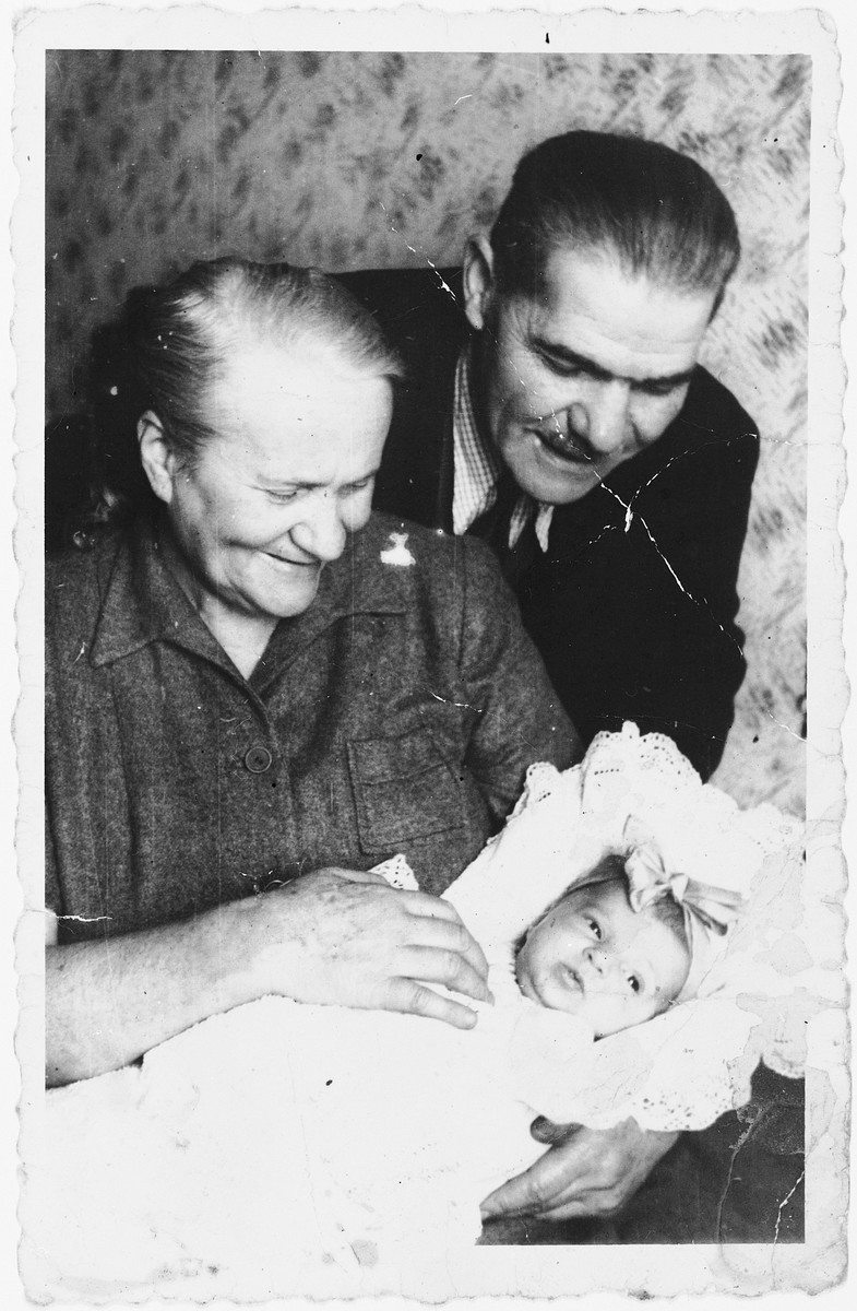 An elderly Jewish DP couple admires their newborn granddaughter in the Ansbach displaced persons camp.

Pictured are Chaim and Chaya Kleinhandler with their granddaughter, Varda.