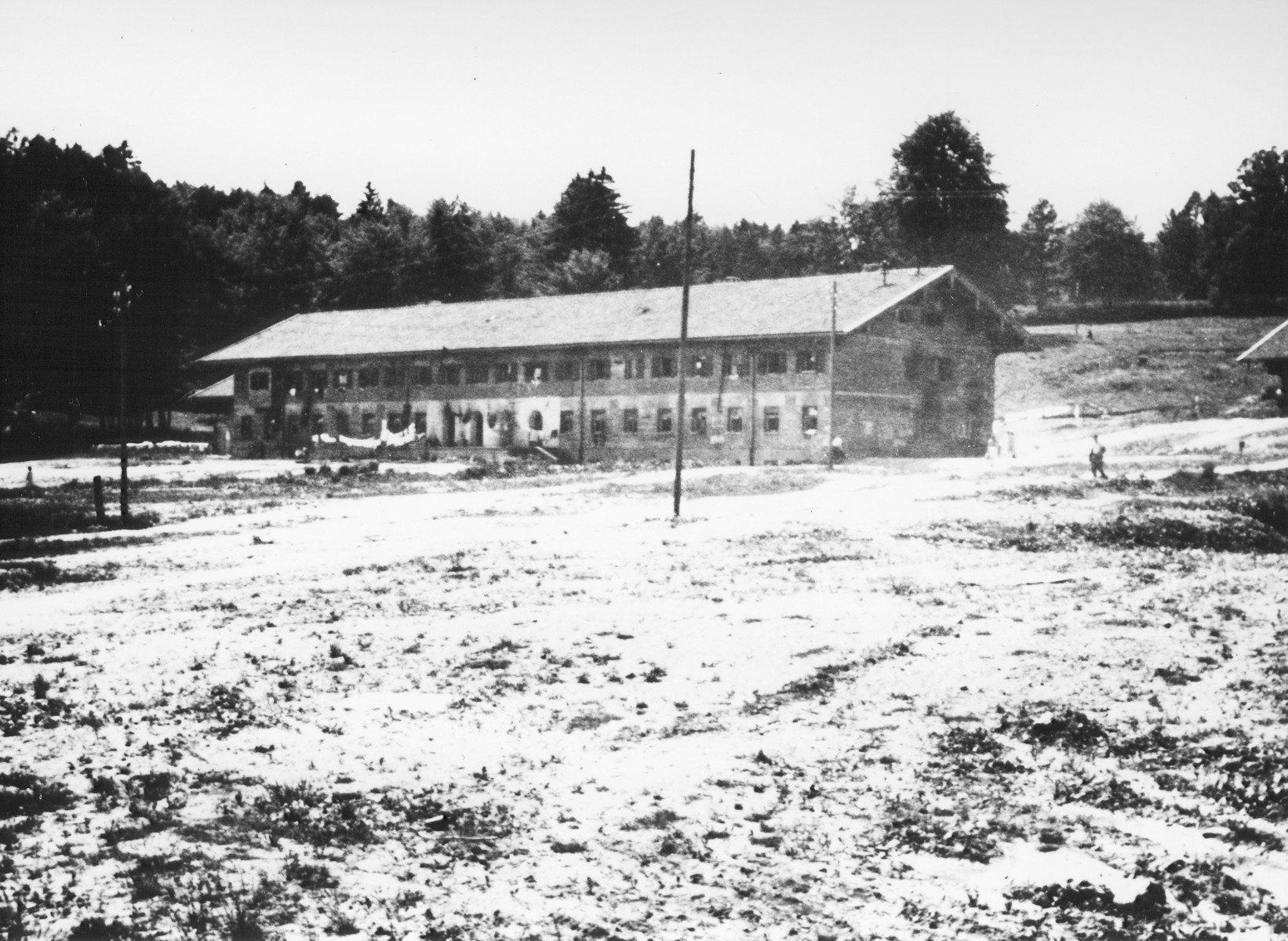 Exterior view of the building which served as living quarters in the Feldafing DP camp.

The  building pictured is a "Sturmblockhaus," built in 1938 to house the Nationalsozialistische Deutsche Oberschule Starnberger See, established on the orders of SA-chief Ernst Roehm in 1934.  In April 1945, the school was dissolved and the building was repurposed to provide housing for displaced persons.