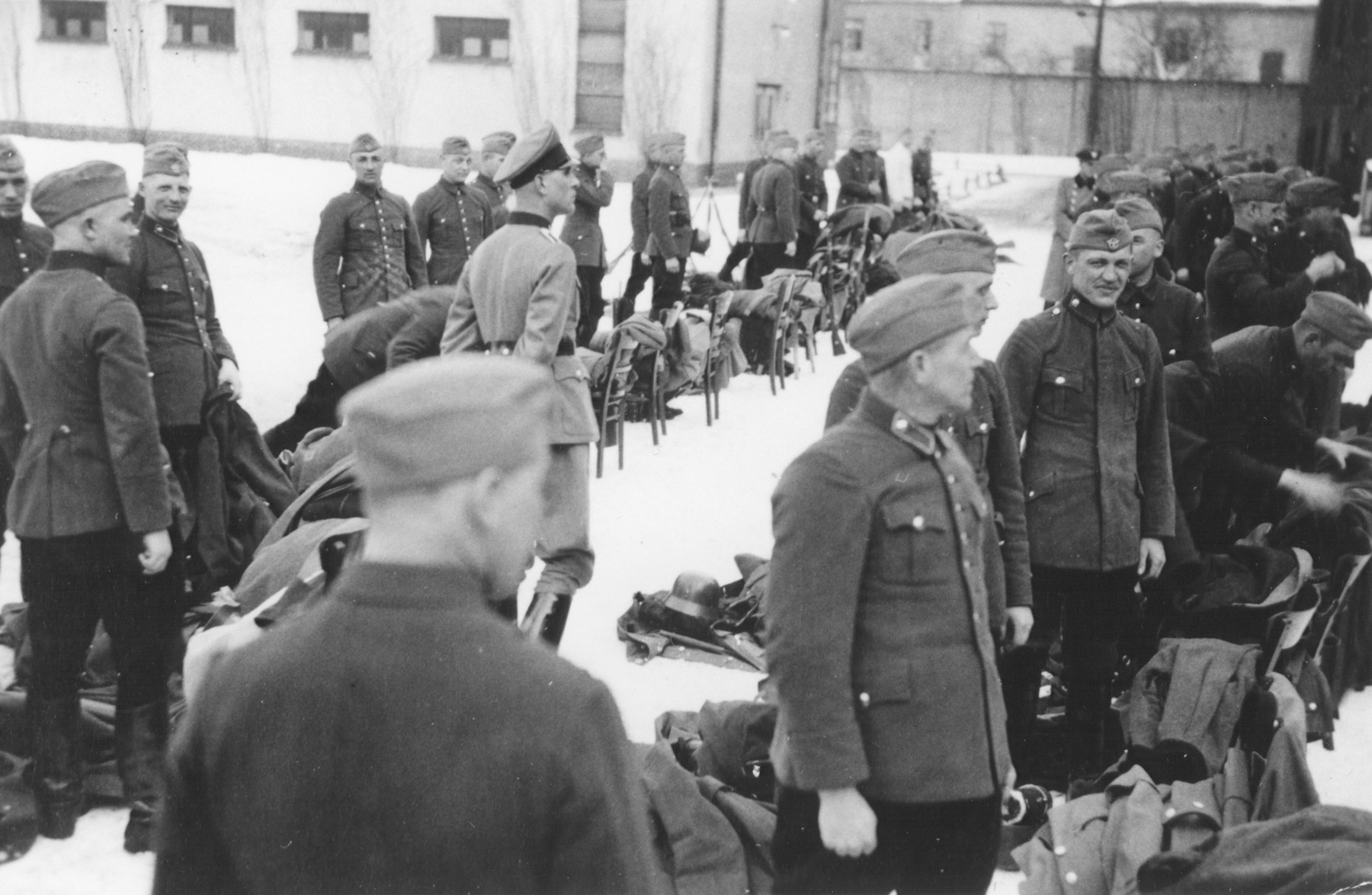 Members of Police Battalion 323 receive new equipment.

Josef Herkert is standing in profile in the front.