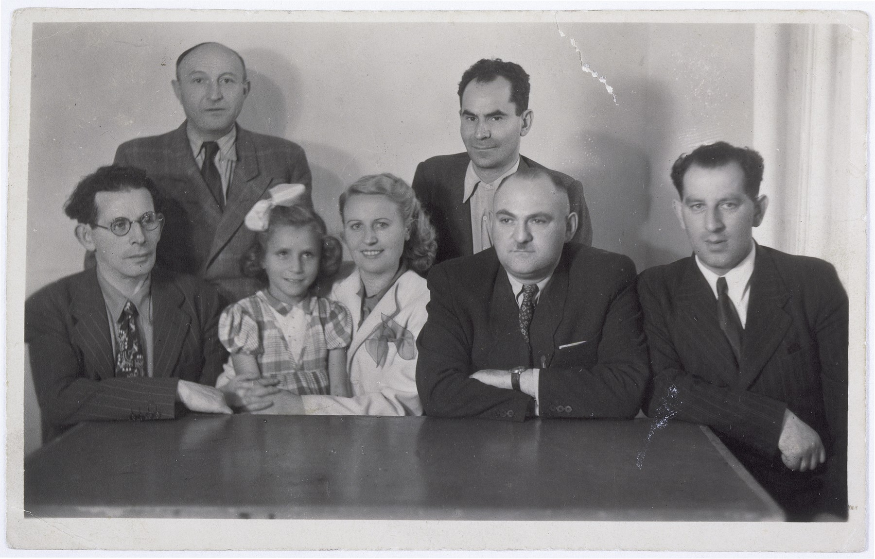 Group portrait of the committee that raised money to take Gitta Rosenzweig out of the Polish orphanage.  Gitta is seated on the lap of Ida Rosenstein.