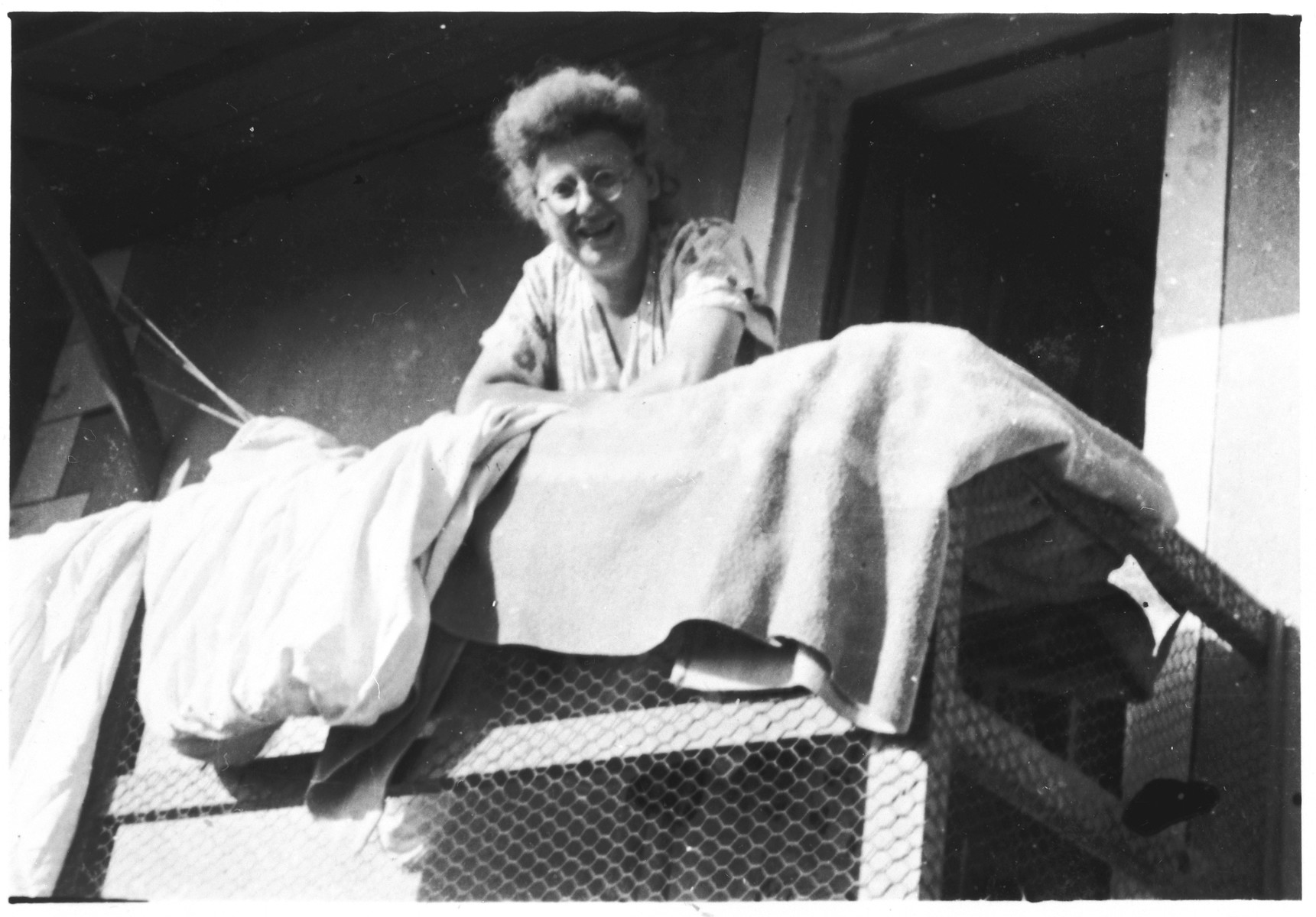 Jeanne Latchiver, a Jewish woman who worked closely with the Armée Juive, poses on the balcony of the mountain chalet in Les Michallons that was used as a training camp by the Jewish resistance group.