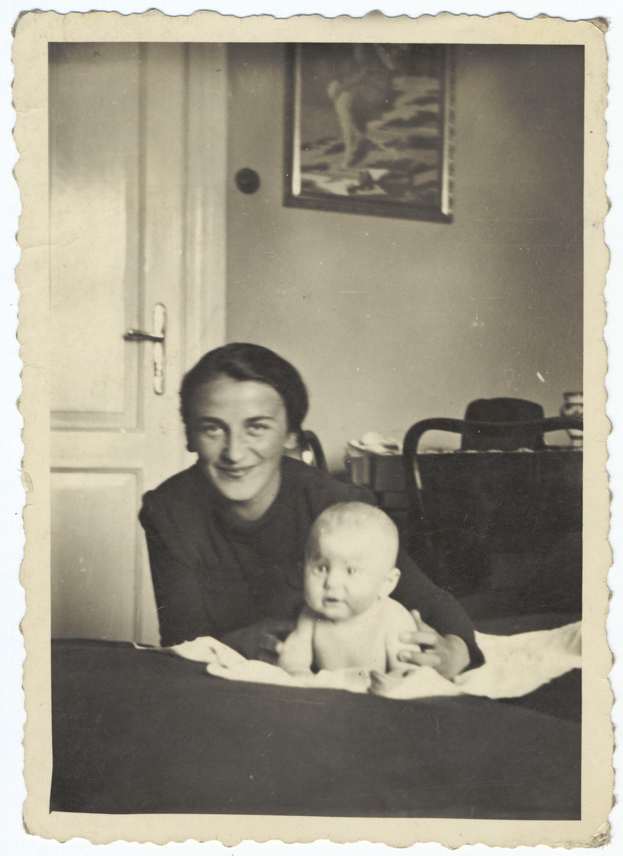 A Jewish mother poses with her newborn daughter inside their home in Krakow prior to the creation of the ghetto.

Pictured are Regina and Stefania Hoffman.