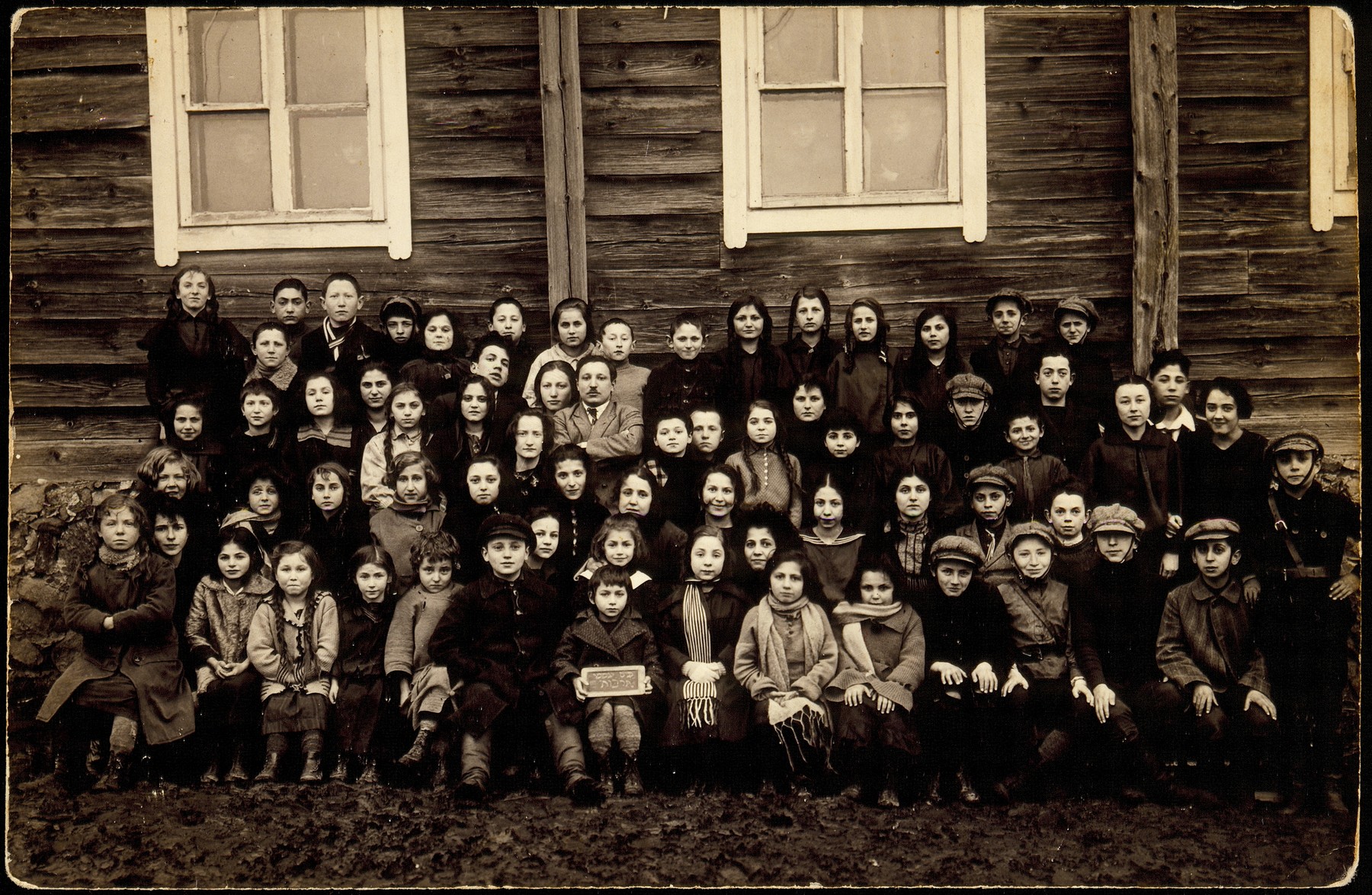 Students of the Tarbut school in Eisiskes. 

The teacher, Mr. Pitochowski is sitting with his arms crossed.