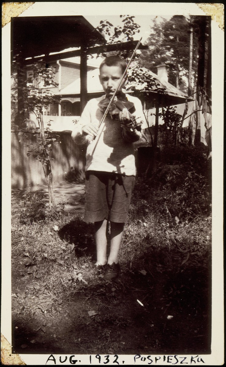 Lova Saposnikow plays his violin near his home outside of Vilna. 

Lova was the son of Sonia Saposnikow.  He perished during the Holocaust